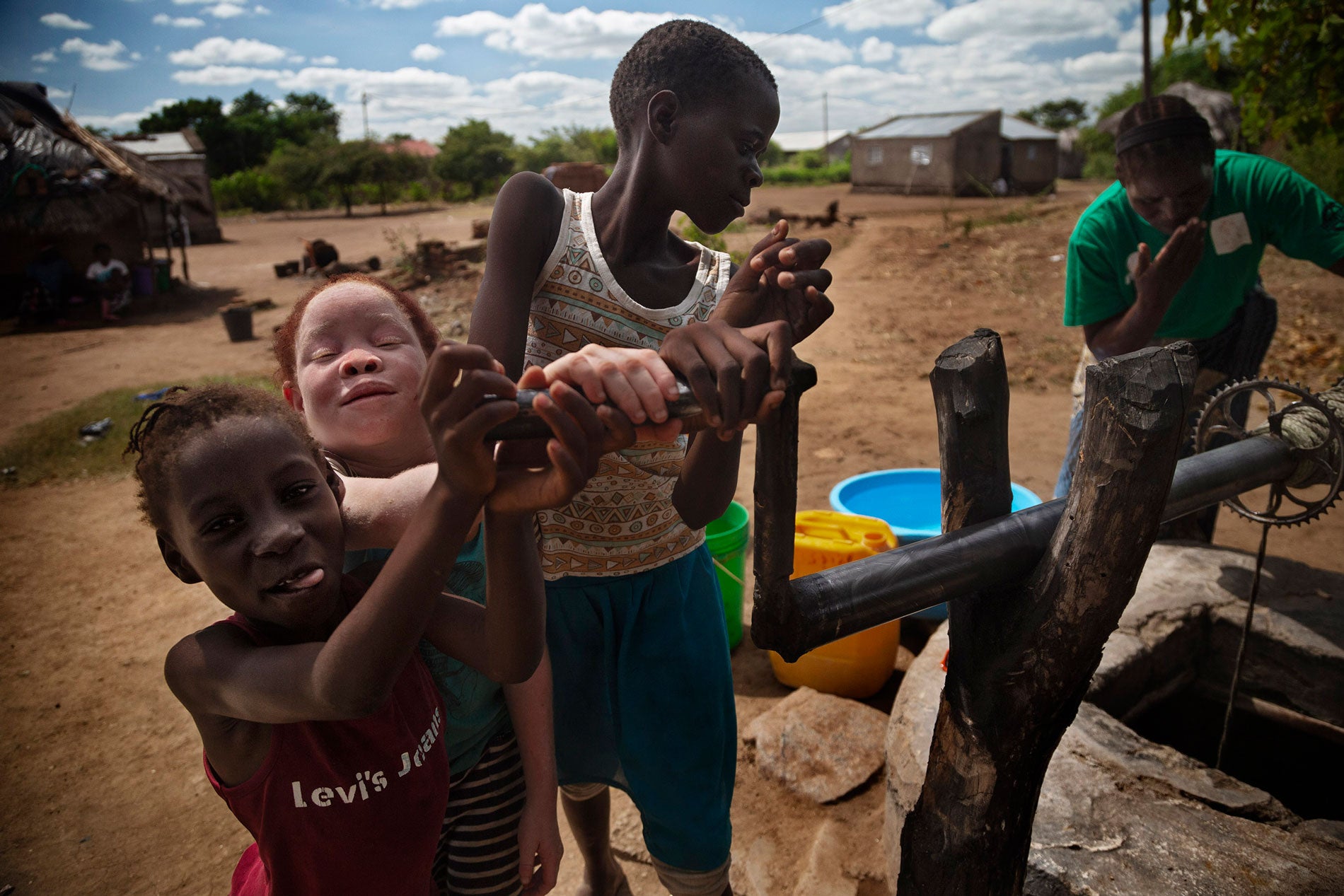 Josina (second from left) playing with her best friend and niece, Luisa (left), both eight at the time.