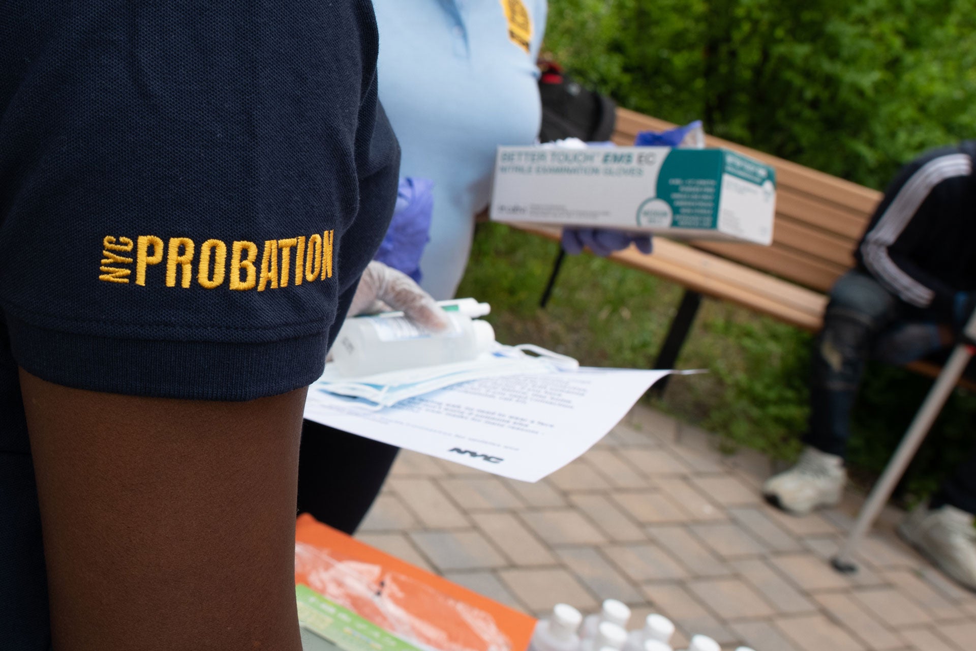 A man's arm is seen and on his shirt sleeve is the word Probation. 