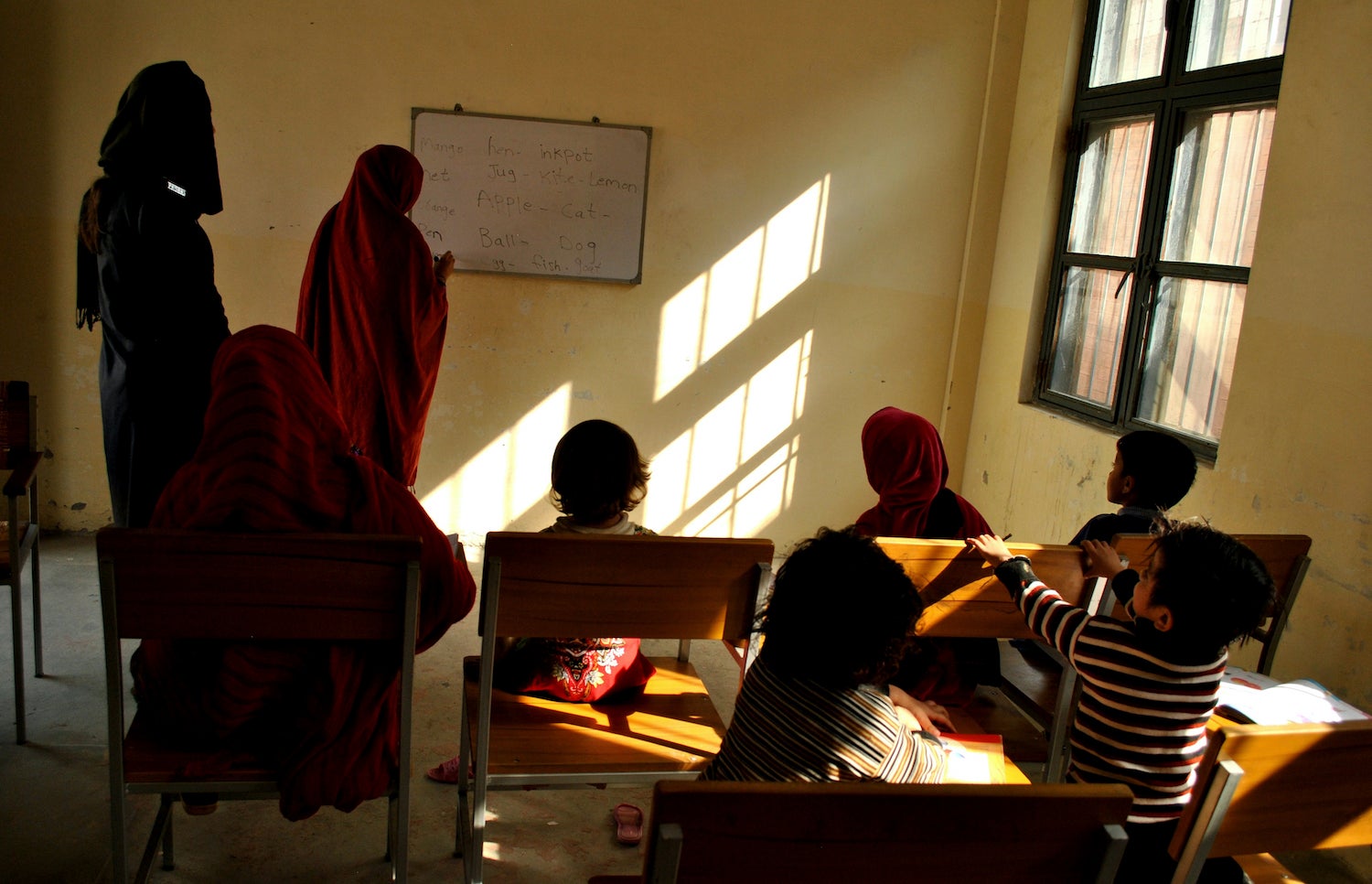 A woman prisoner teaches fellow inmates and their children at a central jail in Mardan, Pakistan, November 8, 2018.