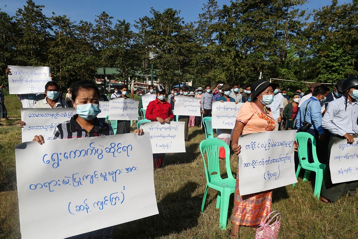 Protesters hold placards that read "Oppose unfair action of election! Investigate voting fraud around the country!" in a rally to condemn the November 8 general election results in Yangon, Myanmar on Friday, November 20, 2020.