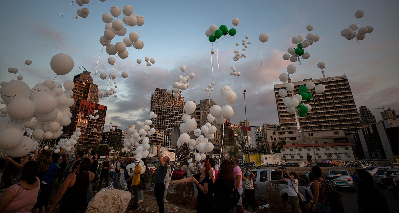 Lebanese people release balloons bearing the names of the victims of the 4 August Beirut seaport blast to mark the two-month anniversary of the explosion that killed 200 people and injured more than 6,500 others.