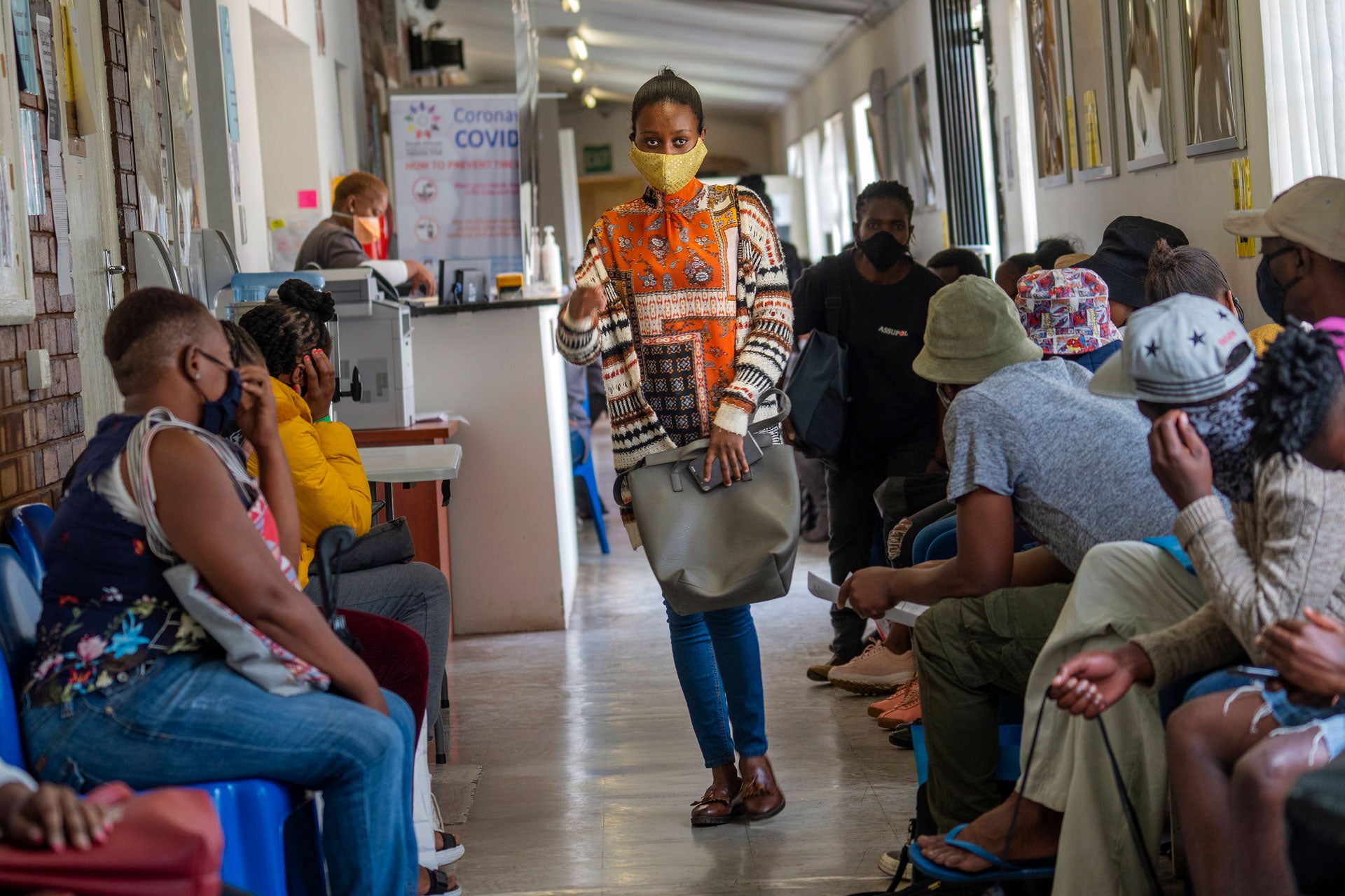 Volunteers wait to be checked at a vaccine trial facility set at Soweto's Chris Sani Baragwanath Hospital outside Johannesburg, South Africa, November 30, 2020. 