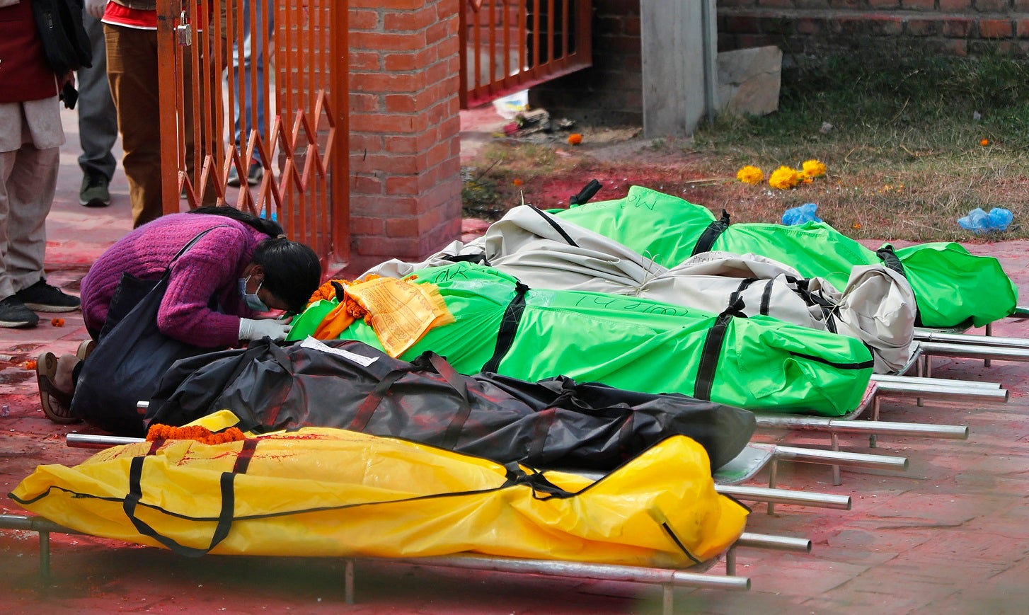 A family member mourns next to the bodies of COVID-19 victims at a crematorium near Pashupatinath temple in Kathmandu, Nepal, May 7, 2021. (AP Photo/Niranjan Shrestha)