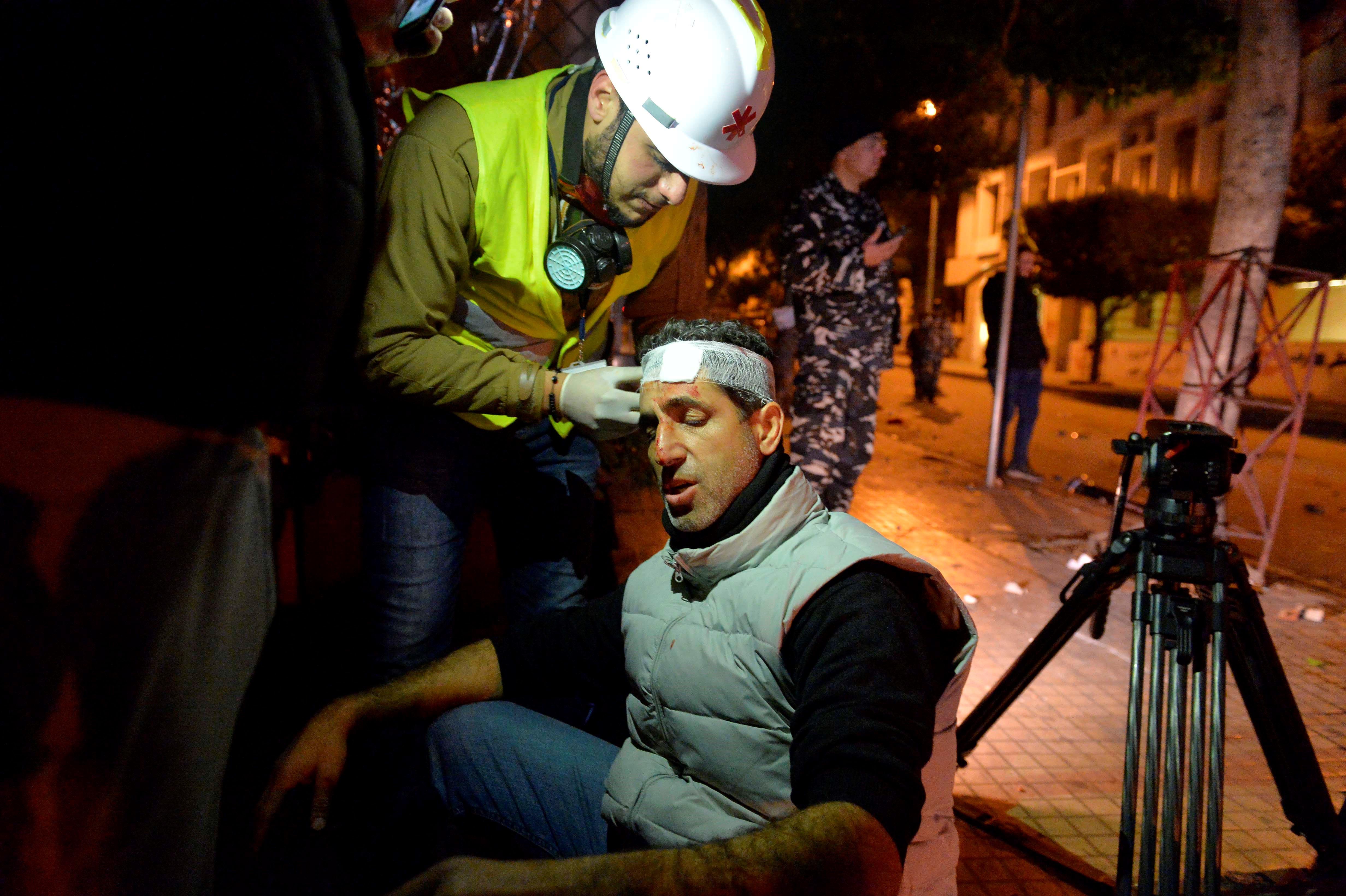 An injured journalist receiving treatment after clashes between security forces and demonstrators during a protest in Beirut, Lebanon on January 14, 2020.