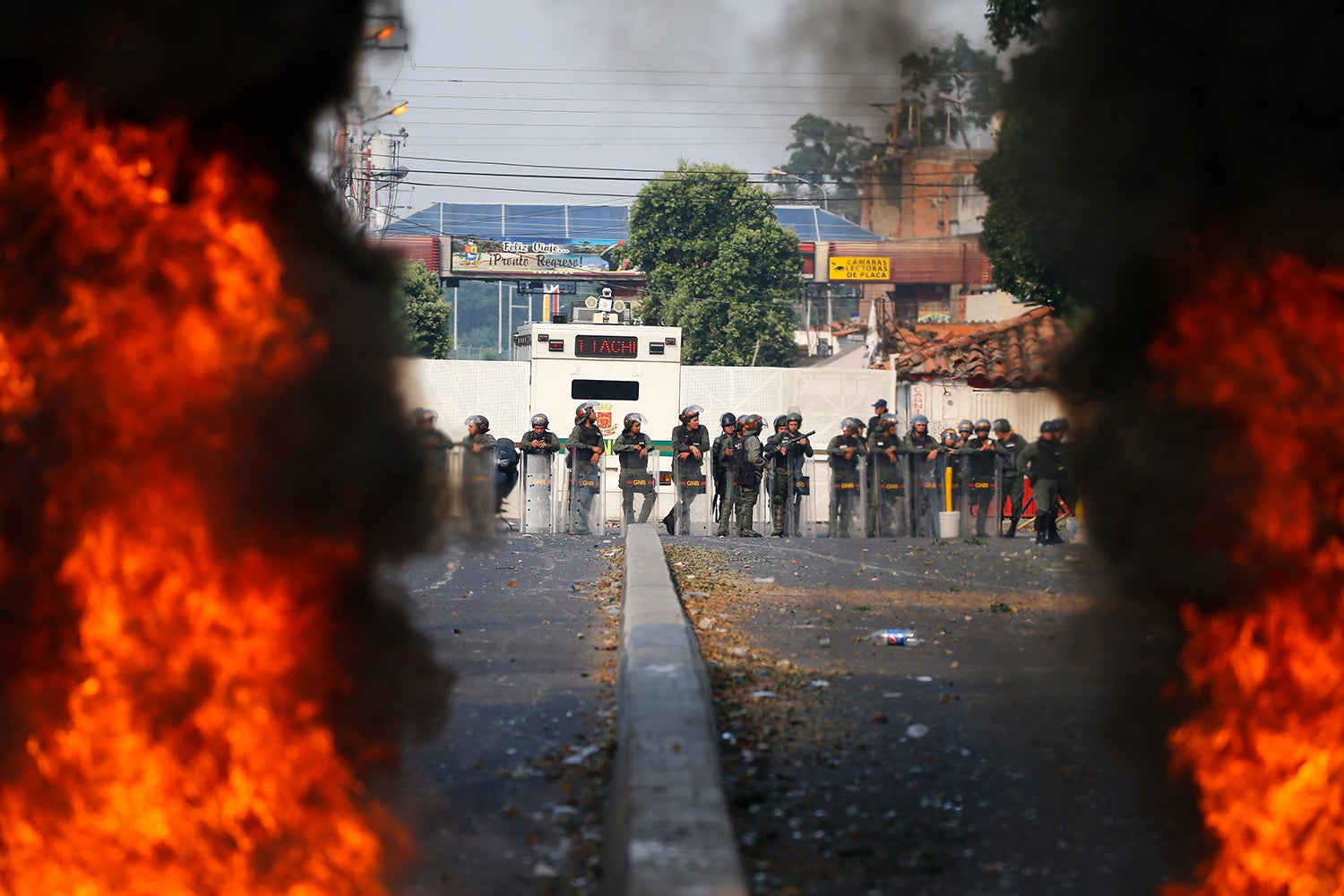 Bolivarian National Guard troops man a barricade blocking access to the Francisco De Paula Santander international bridge in Urena, Venezuela, on the border with Colombia, through which humanitarian aid was going to enter the country, on Saturday, Feb. 23, 2019.