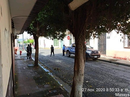 Armed police officers on an empty residential street