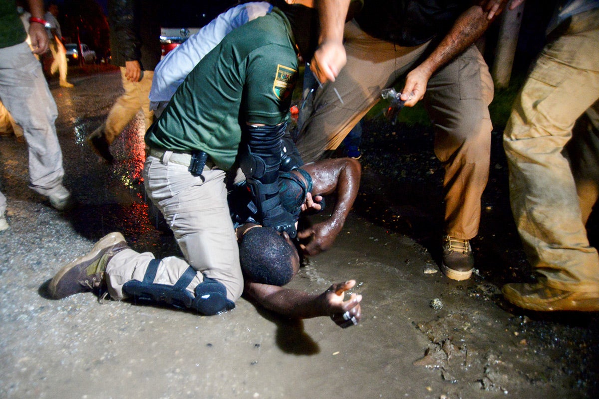 Agents of the National Migration Institute detain a migrant during an operation to halt the progress of a caravan of migrants and asylum seekers in Chiapas state, Mexico on September 1, 2021.