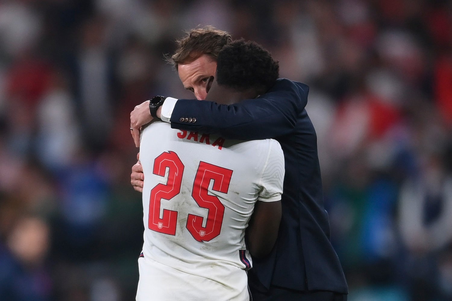 England’s Bukayo Saka (left) is consoled by England's manager Gareth Southgate (right) after the Euro 2020 soccer final match between England and Italy at Wembley stadium in London on July 11, 2021.