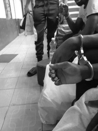 A close-up photo of hands in handcuffs
