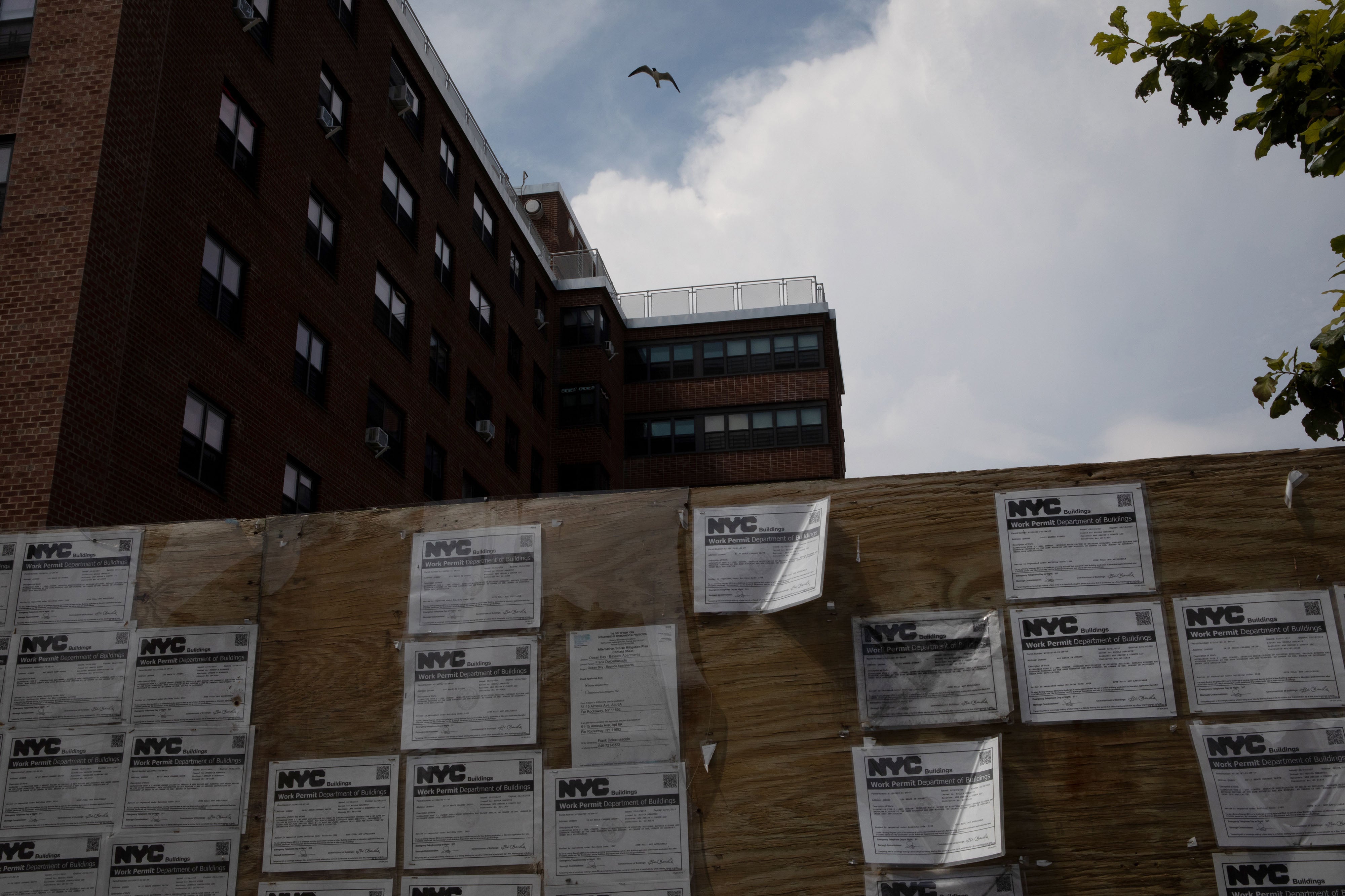 Work permits displayed in front of an apartment complex