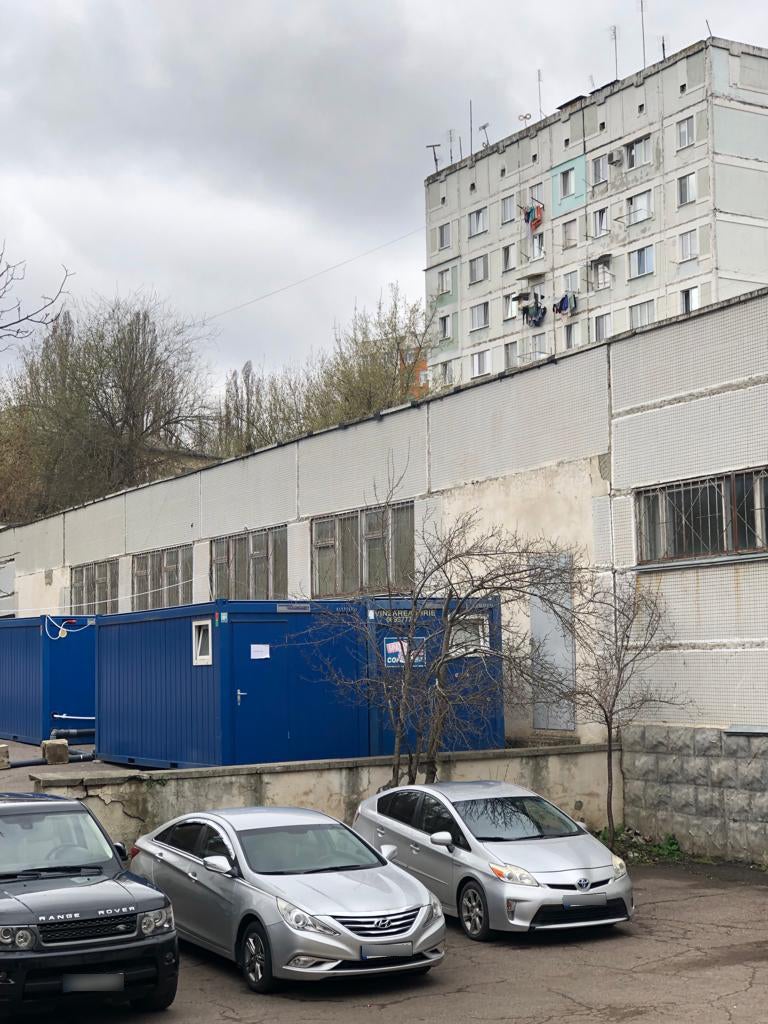 Containers outside of FRISPA with showers. In the first days after Romani refugees from Ukraine moved in, there was only one shower with a small boiler. Chisinau, Moldova, April 2022.