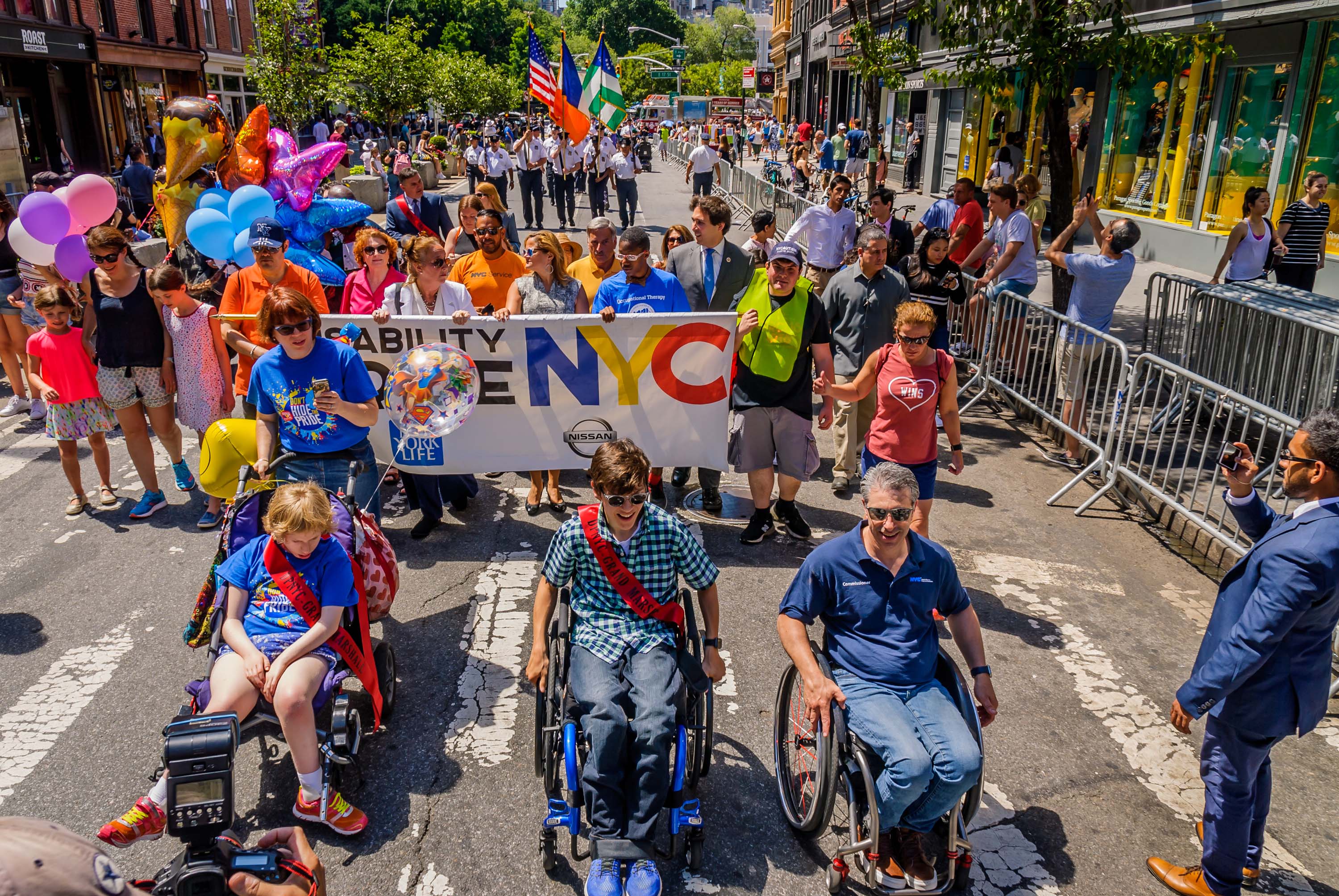A group of parade marchers on a city street 