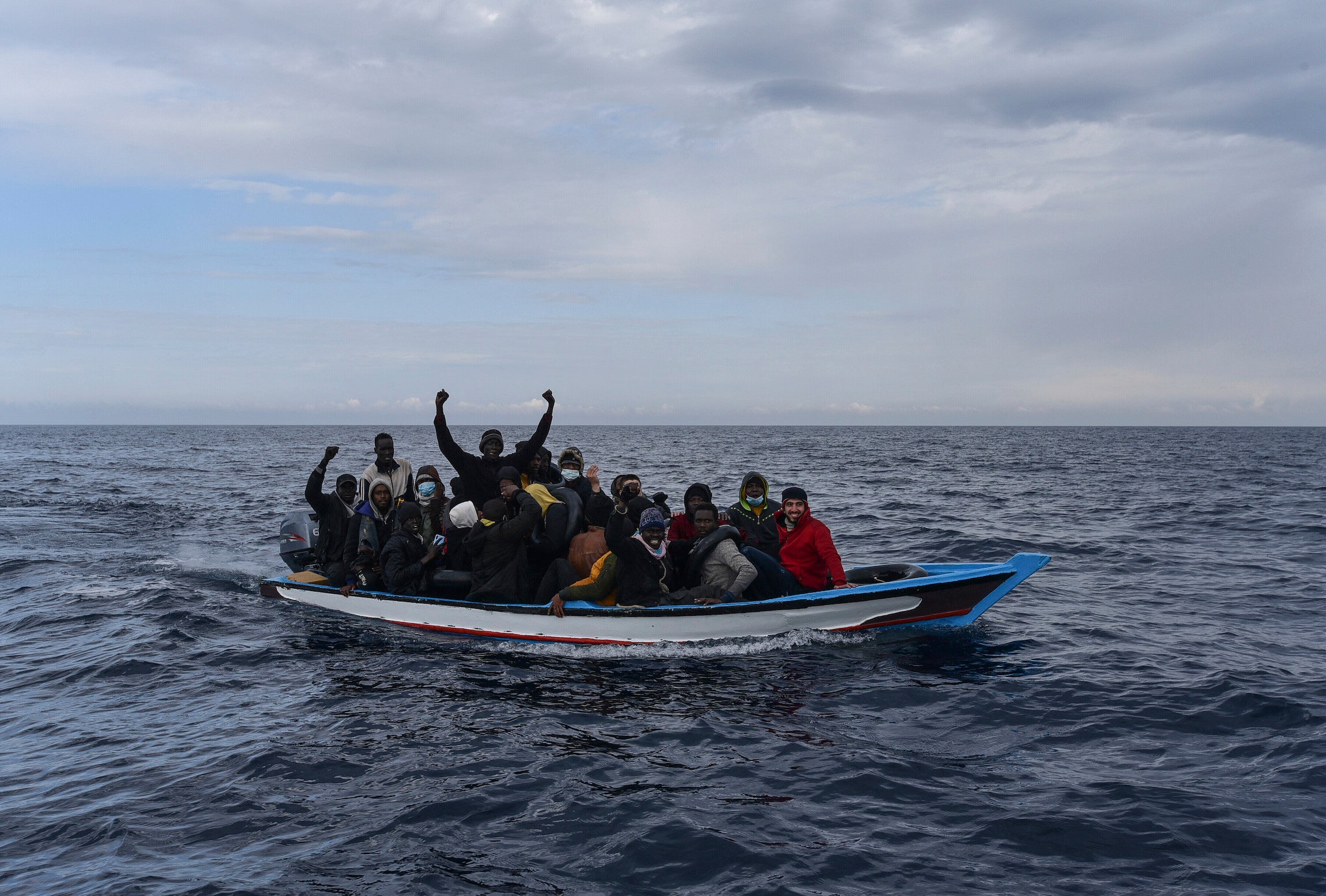 Migrants aboard on a wooden boat in the Mediterranean Sea.