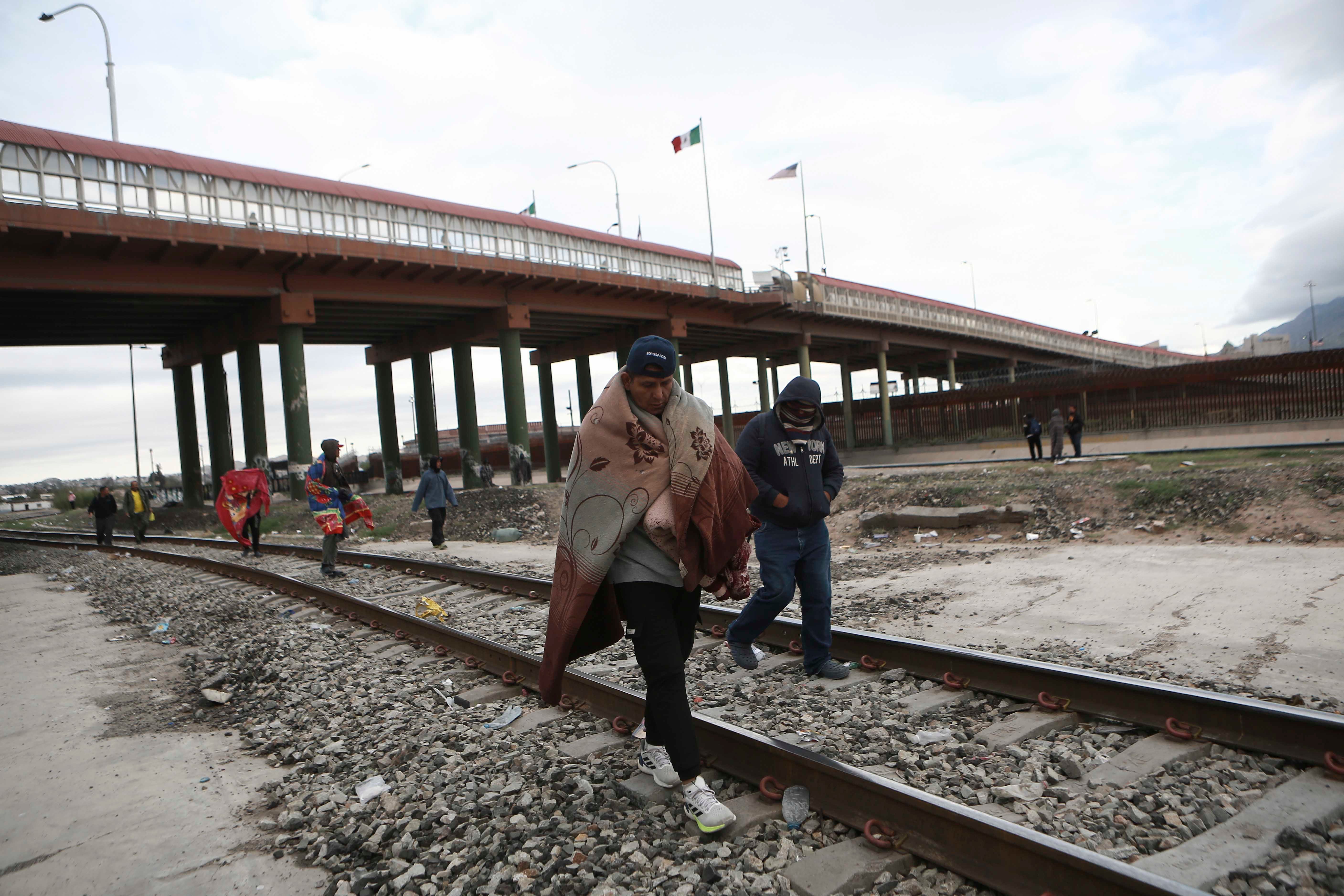 Venezuelans walk near a bridge that crosses the Rio Grande River after being expelled from the United States into Ciudad Juarez, Mexico, Tuesday, Oct. 18, 2022. The Biden administration announced on Oct. 12, that Venezuelans who cross the border irregularly will be immediately expelled to Mexico without being allowed to seek asylum.
