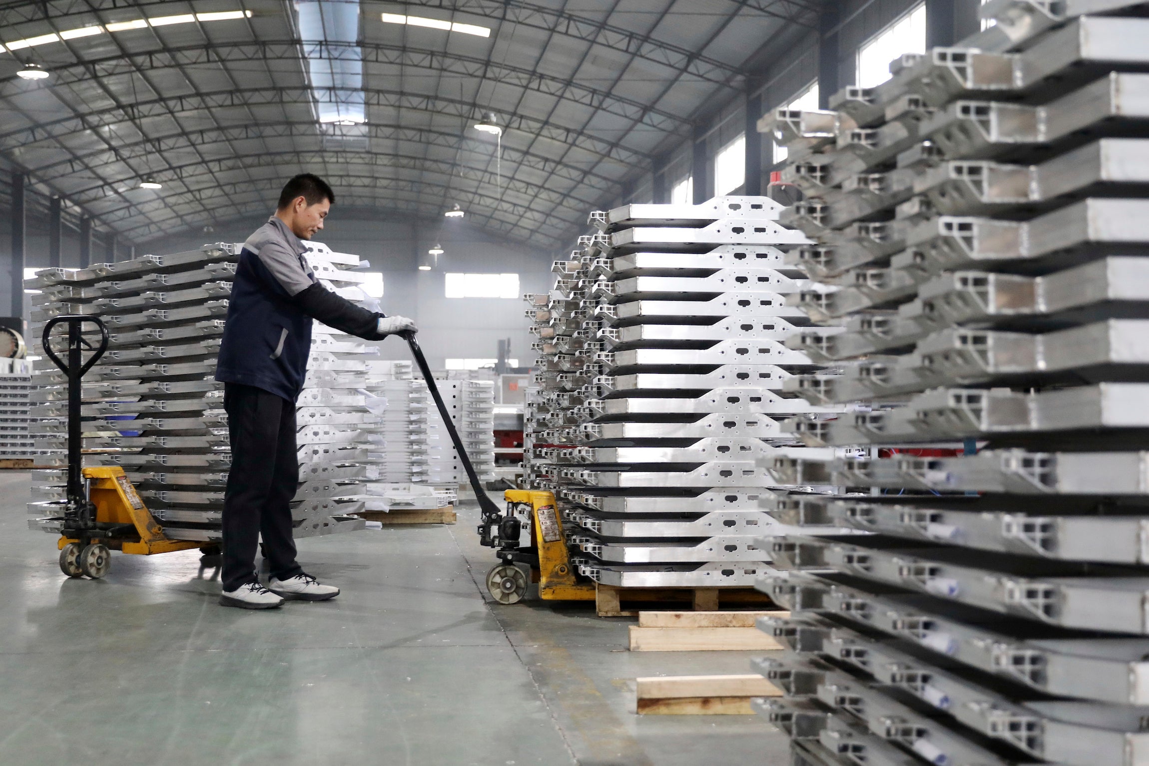A worker moves aluminum auto parts in central China's Anhui province.