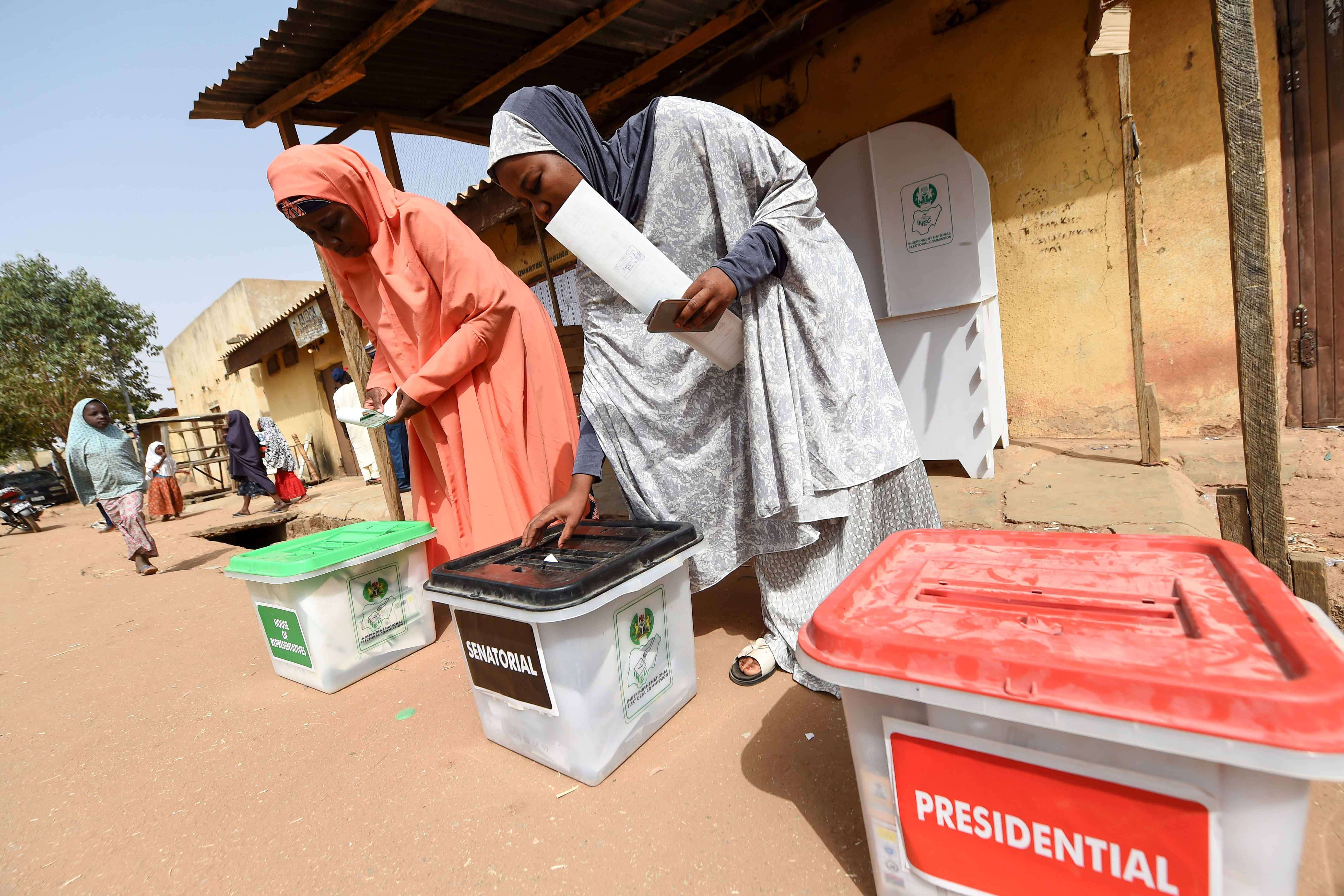 Women cast their ballots as they vote in the presidential and parliamentary elections on February 23, 2019, at a polling station in Daura, Katsina State, northwest Nigeria. 