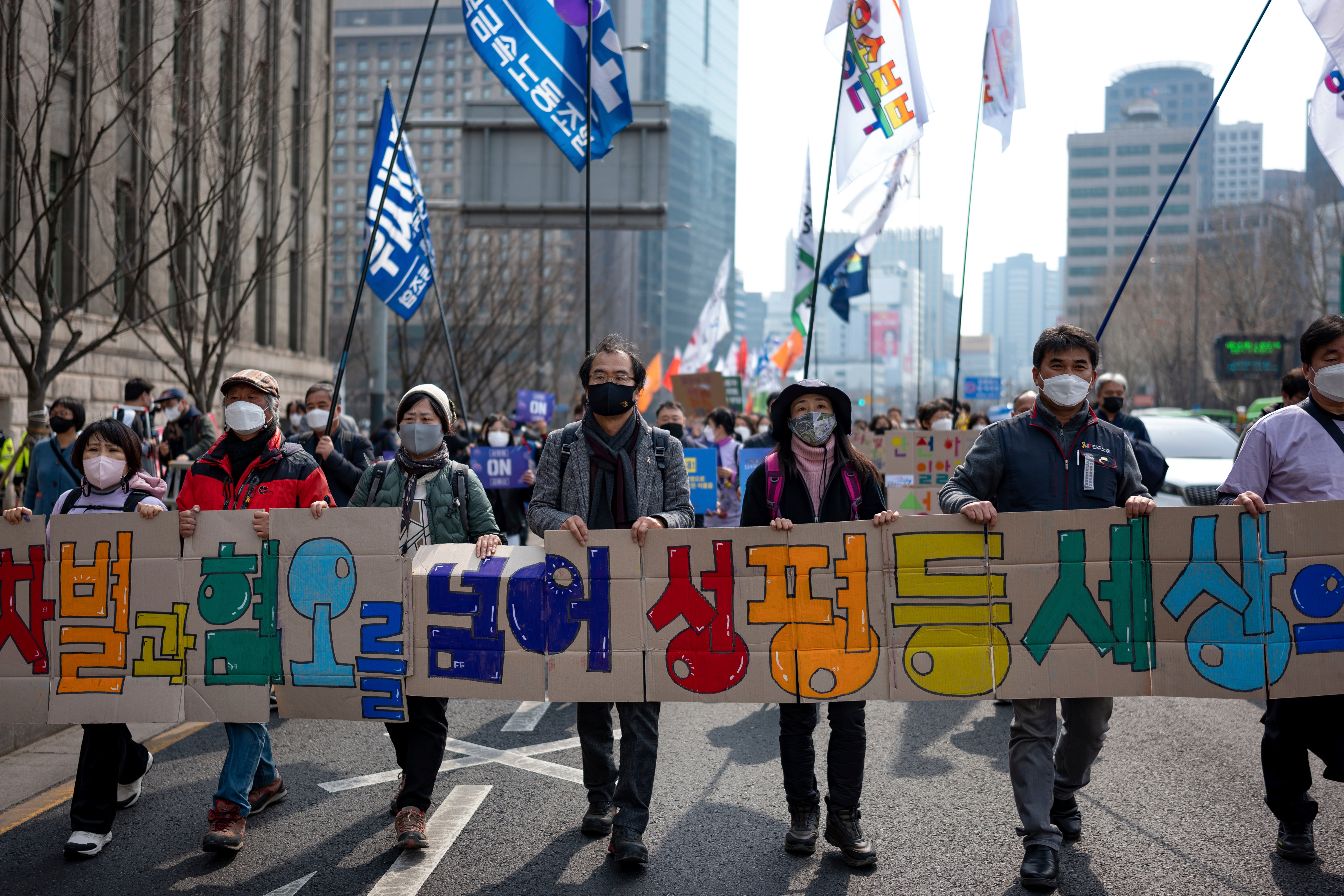 Civil society organizations and activists march in a rally for International Women's Day