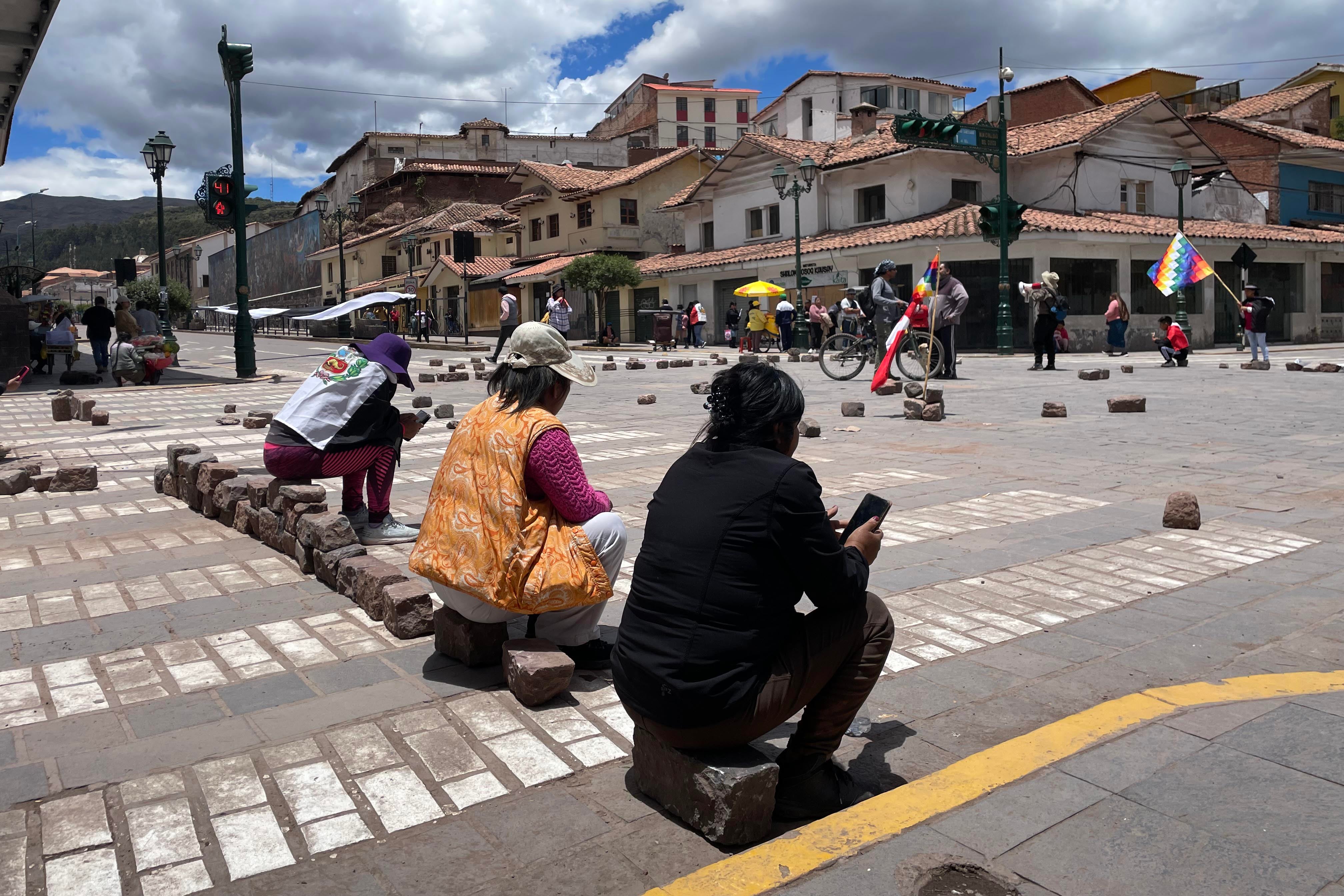 People seated at a roadblock