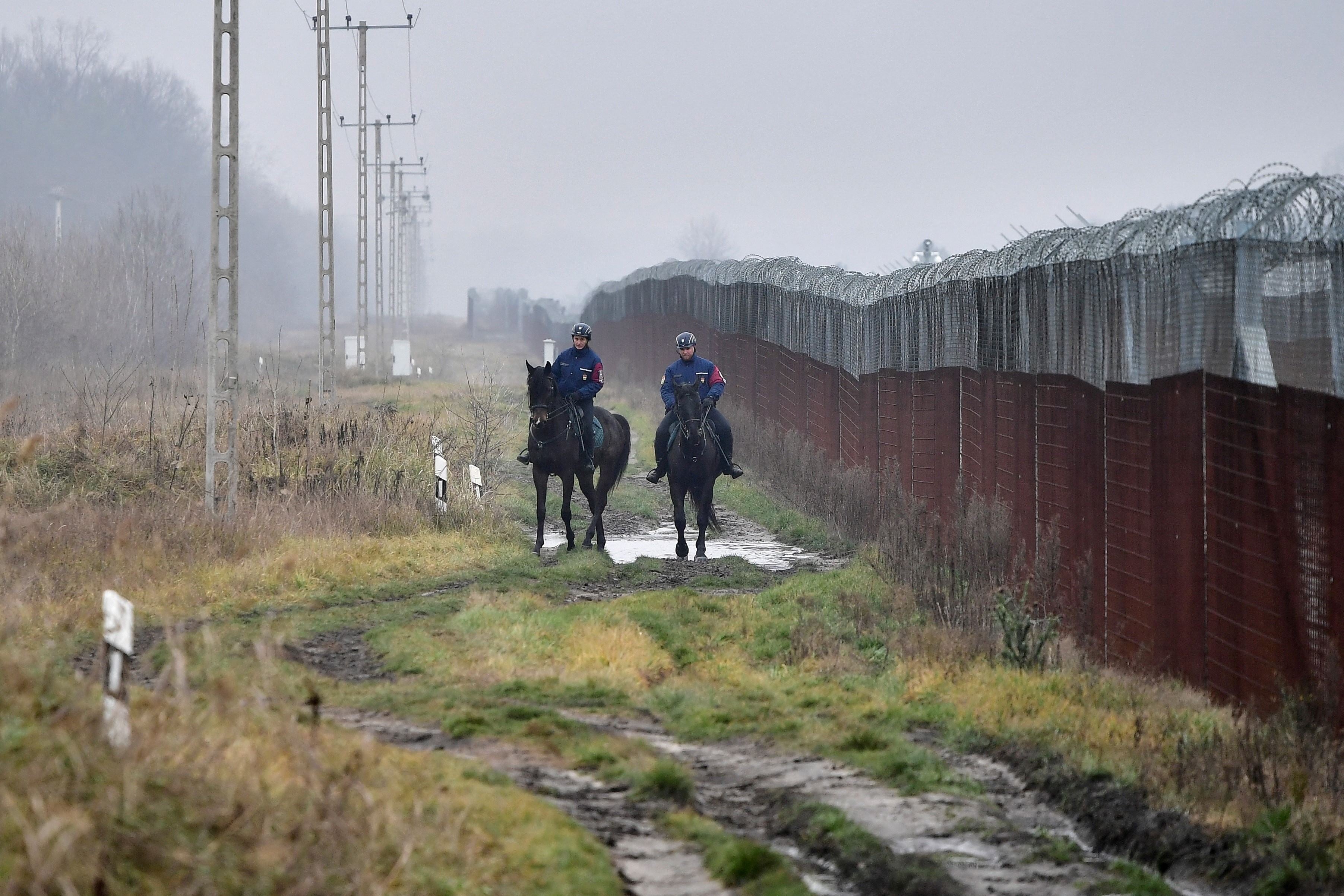 Police patrol the Hungarian-Serbian border barrier near Kelebia, Hungary, December 15, 2022. 