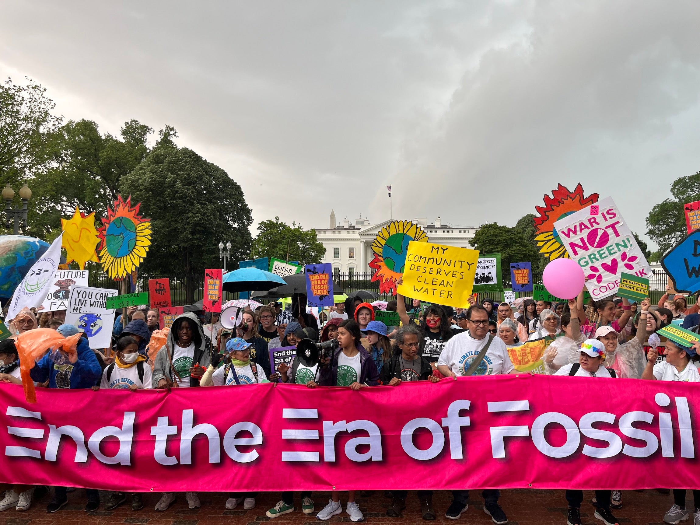 On Earth Day, marchers at the Whit House hold  a banner reading, “End the Era of Fossil Fuels” Washington, DC.