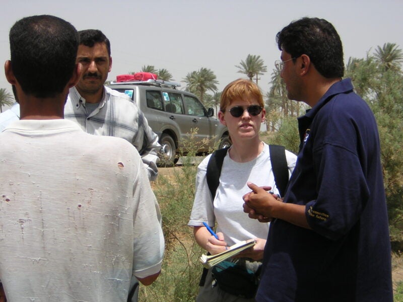 Interpreter Razzaq al-Saiedi (right) and Bonnie Docherty (left) interview Iraqis affected by cluster munitions near al-Hilla in May 2003. 