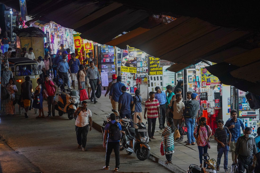 People walk on Pettah Street in Colombo, Sri Lanka, on February 3, 2023.