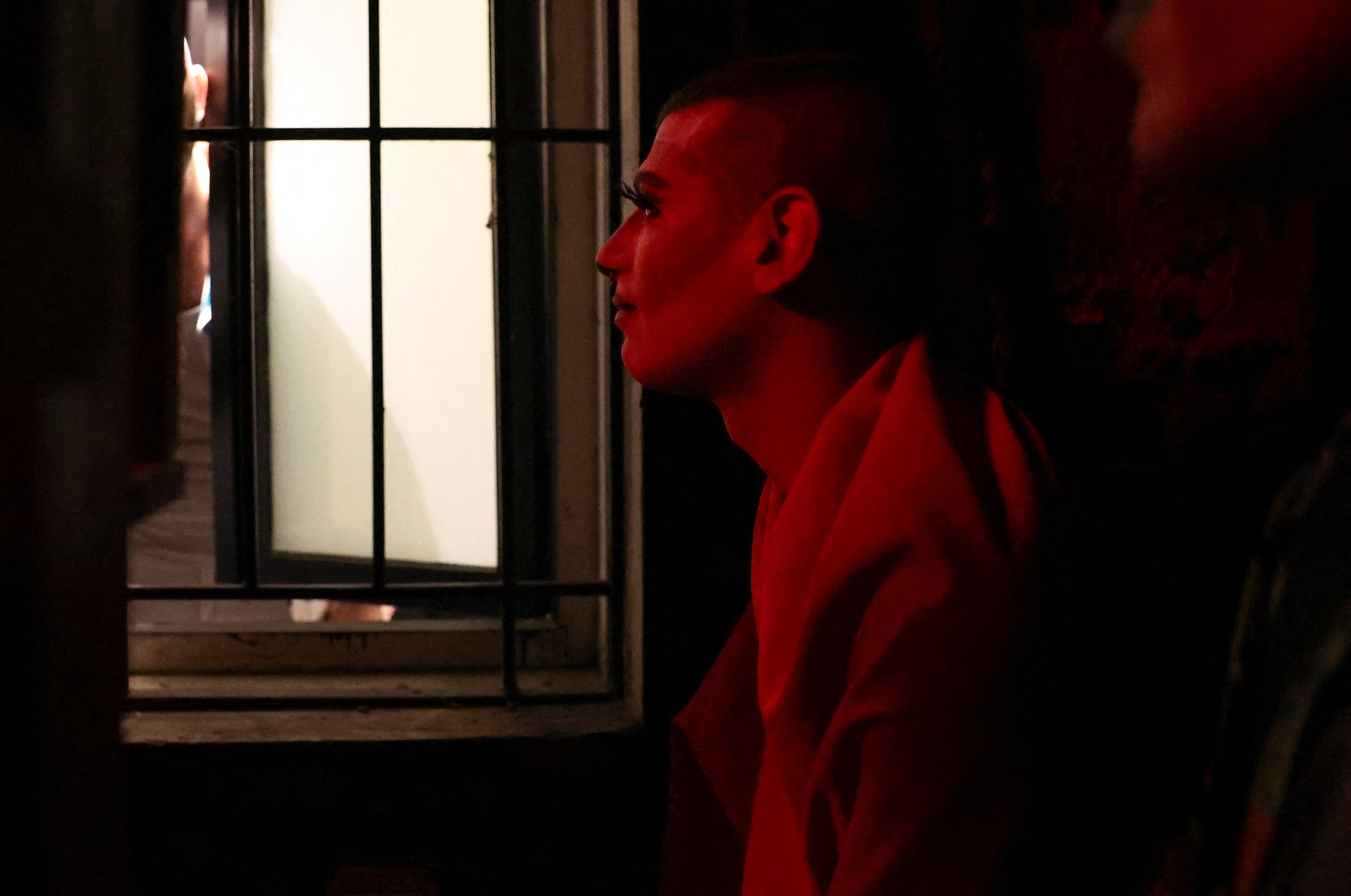 The drag artist known as Latiza Bombe hides on the terrace of a bar after it was attacked by a group of conservative Christians who identify as the “Soldiers of God,” in Beirut, Lebanon, August 23, 2023.