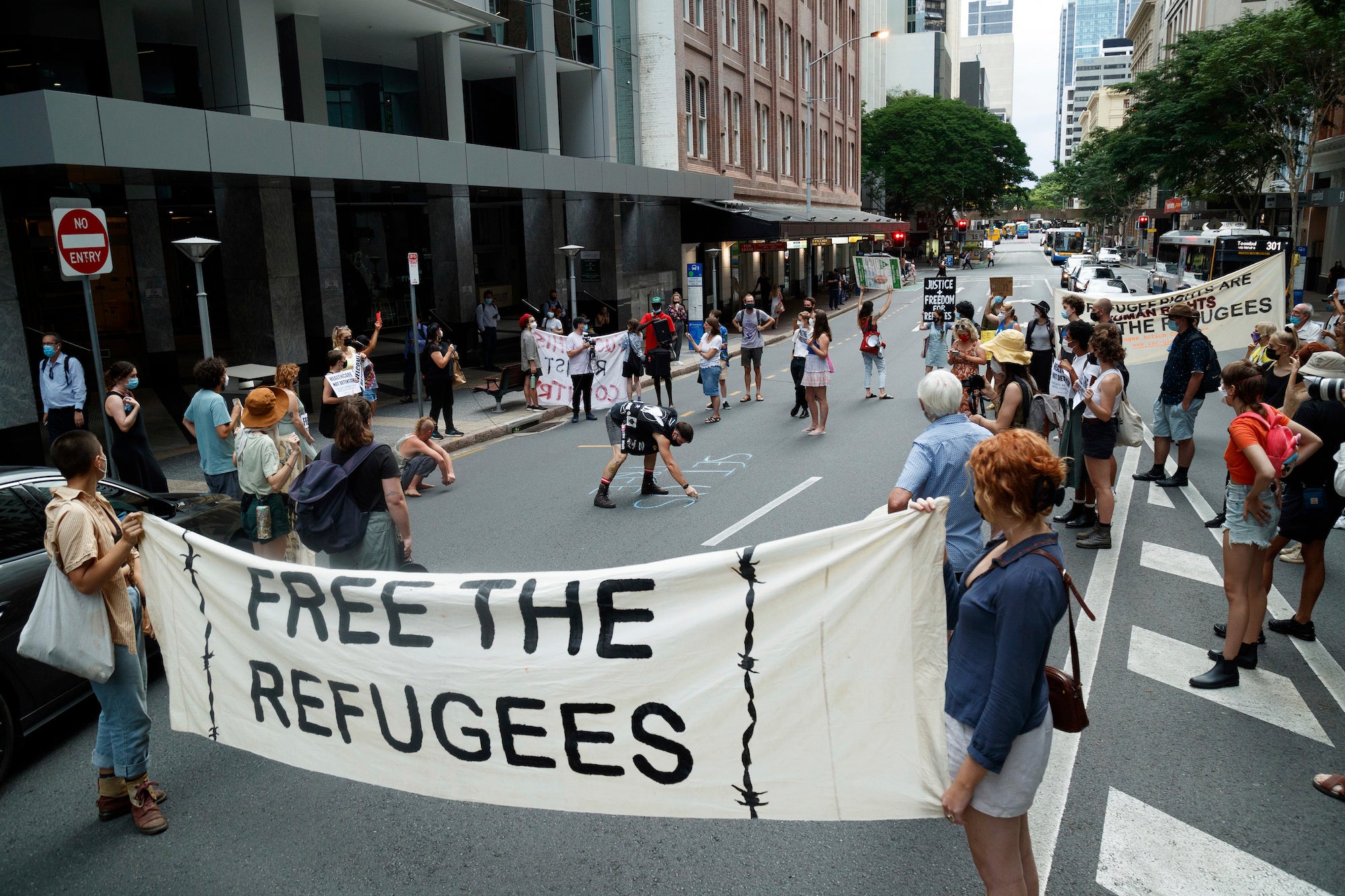 Activists gather in Brisbane's ANZAC Square to protest the indefinite detention of refugees and asylum seekers in Australian-run and funded facilities on the mainland and on Papua New Guinea's Manus Island, January 19, 2022.