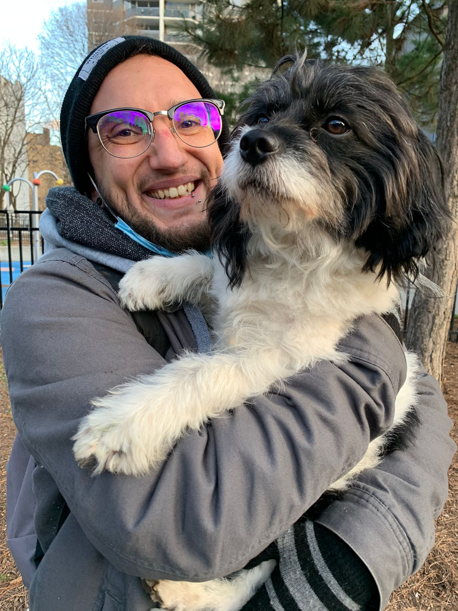 A crisis worker smiles while holding a dog