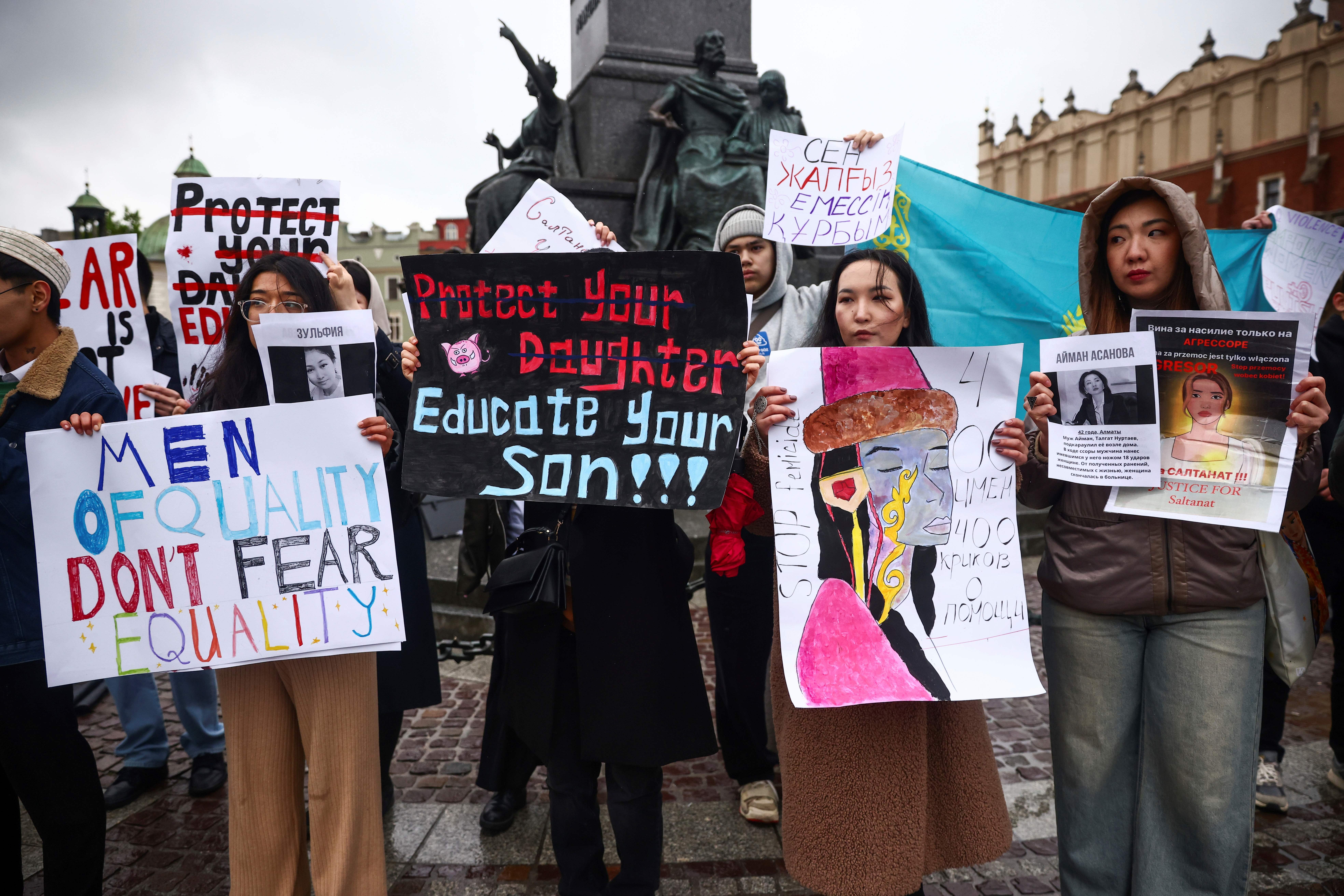 Demonstrators hold protest signs