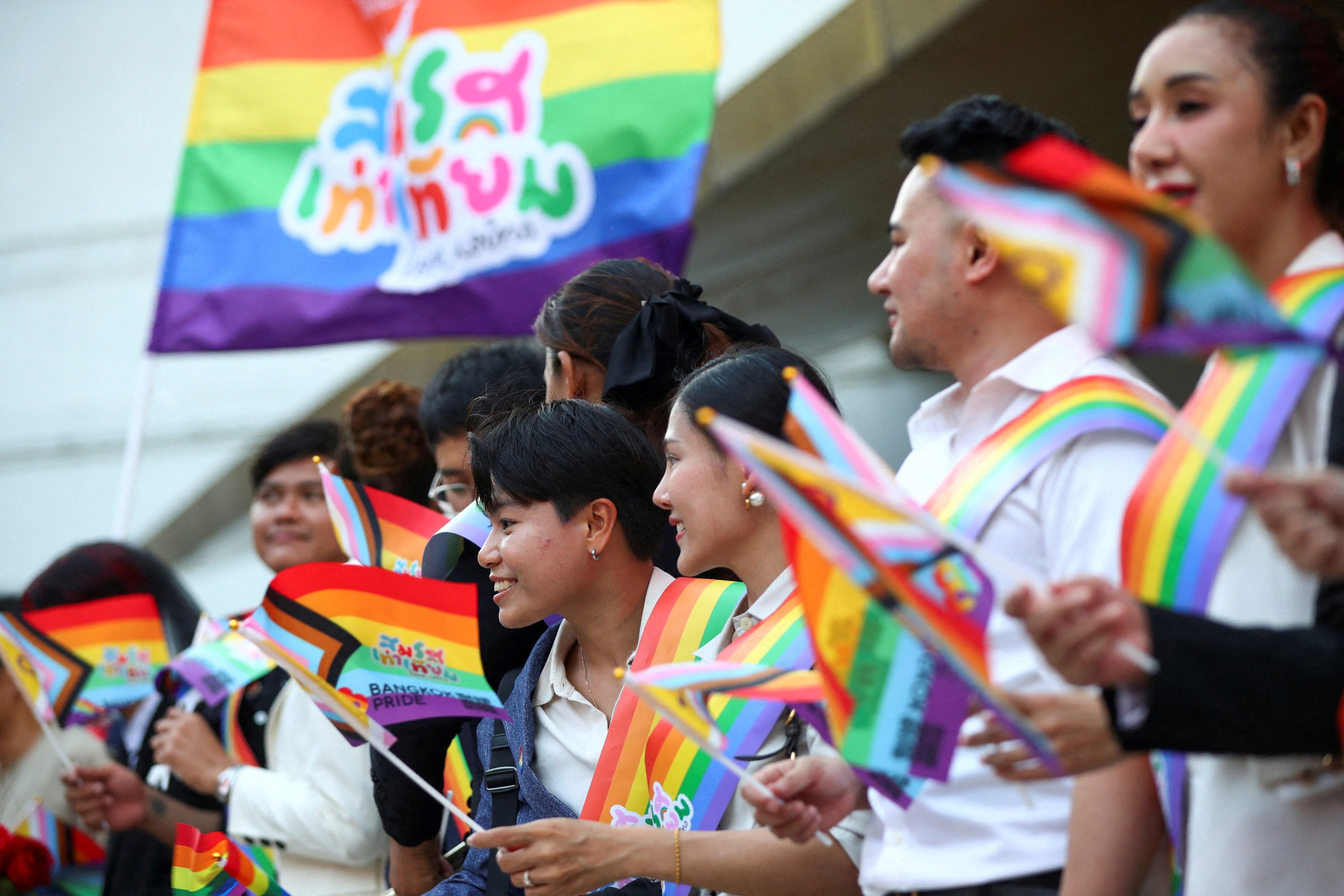 People in Bangkok hold rainbow flags celebrating the passage of Thailand’s Marriage Equality Act, June 18, 2024.