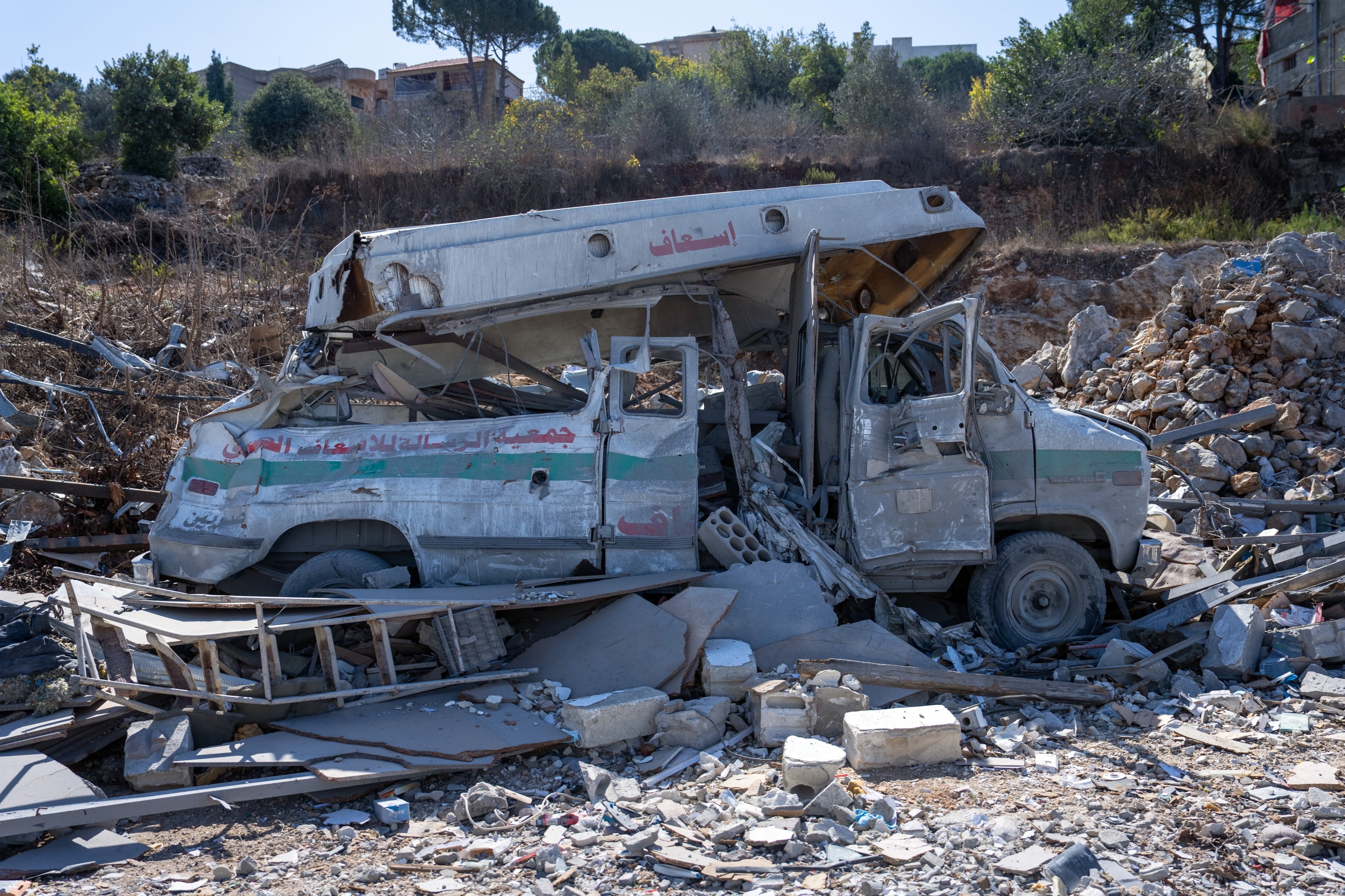 An ambulance lies destroyed in the rubble of an Israeli airstrike in Kafra, Lebanon on October 9, 2024.