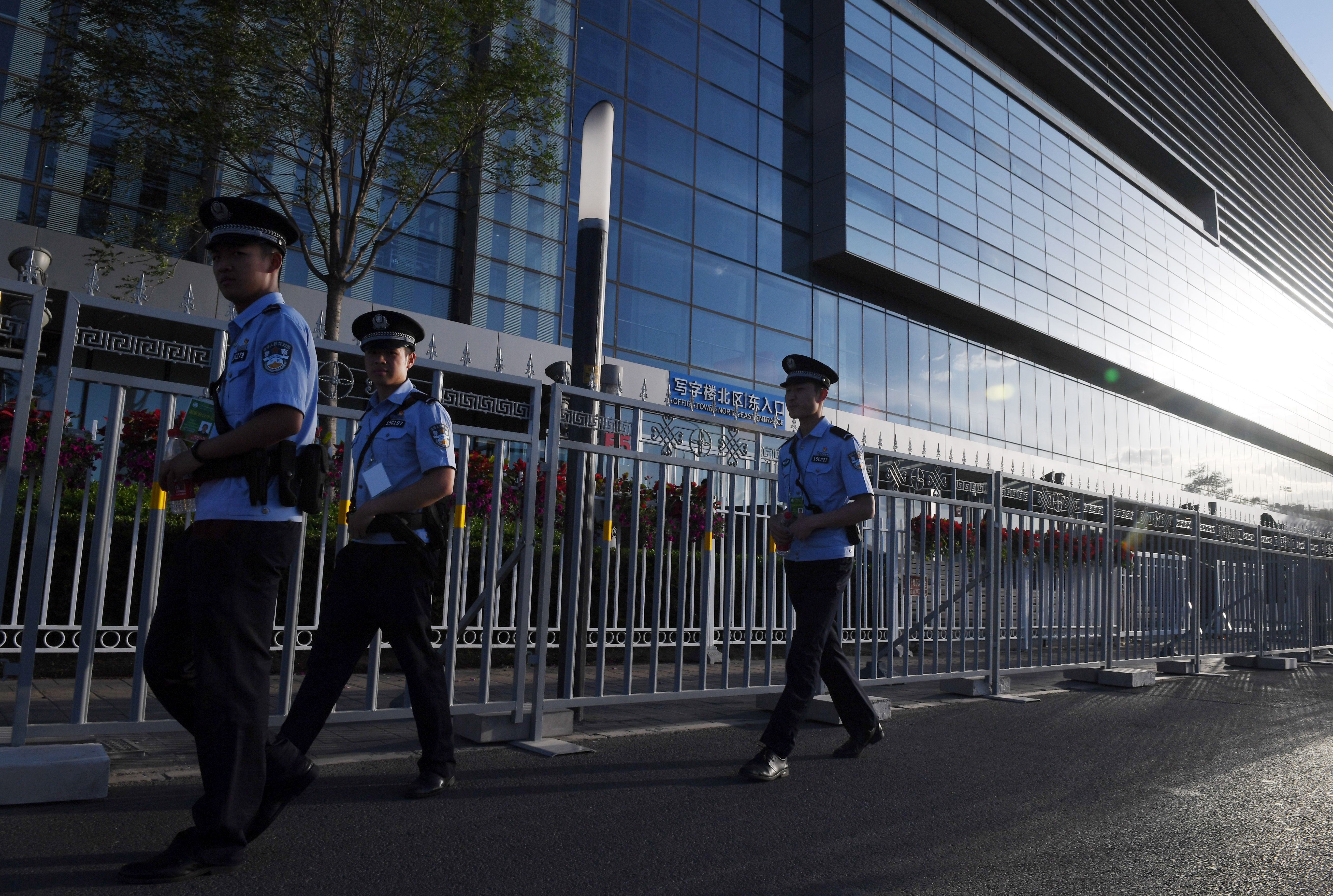 Police officers patrol outside the China National Convention Center in Beijing, May 13, 2017. (