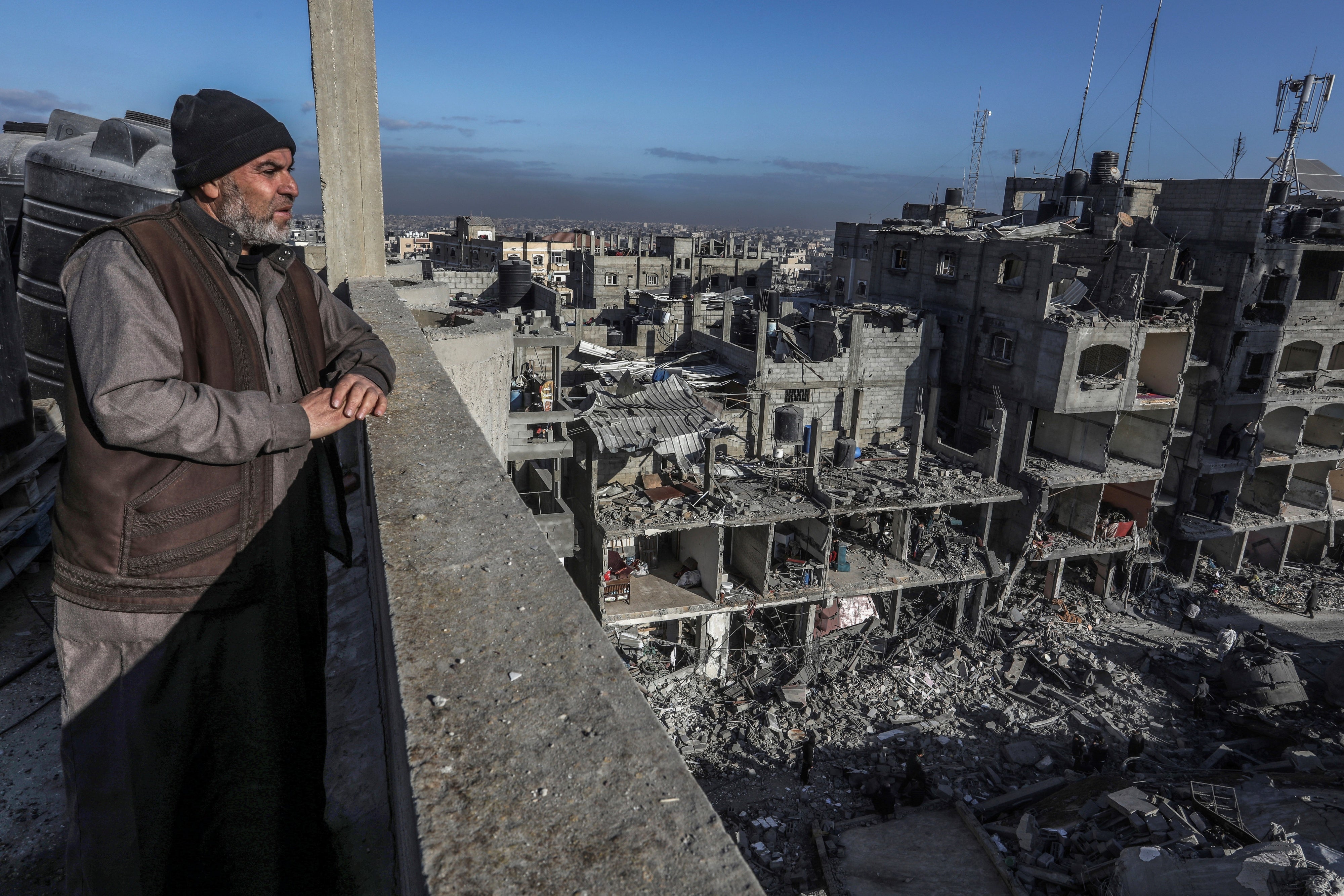 A Palestinian man looks at the destruction of al-Farouq Mosque and other nearby houses caused by Israeli attacks