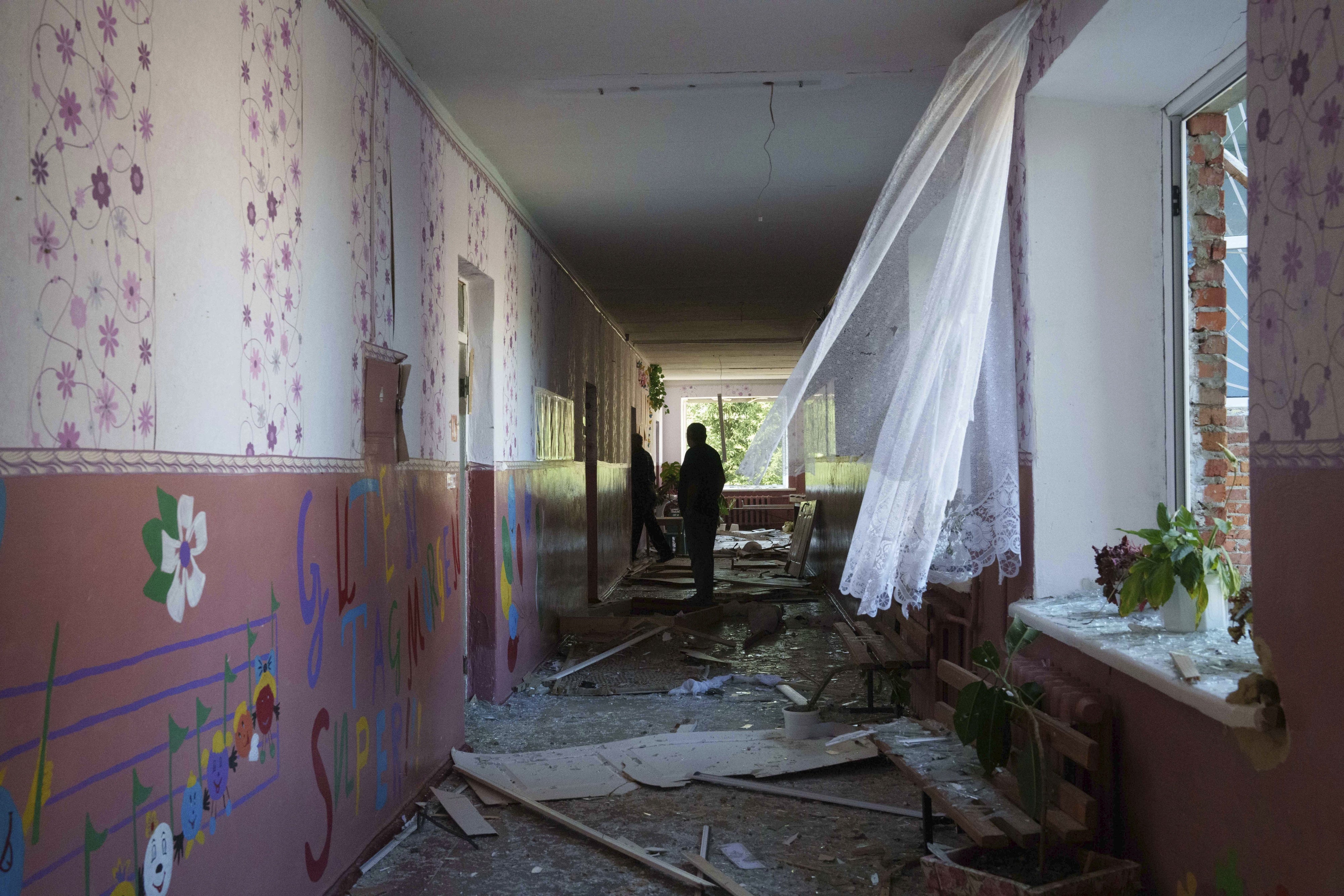  A school guard walks in the corridor of a school which was heavily damaged after a Russian airstrike in Mohrytsia, Ukraine, August 14, 2024.