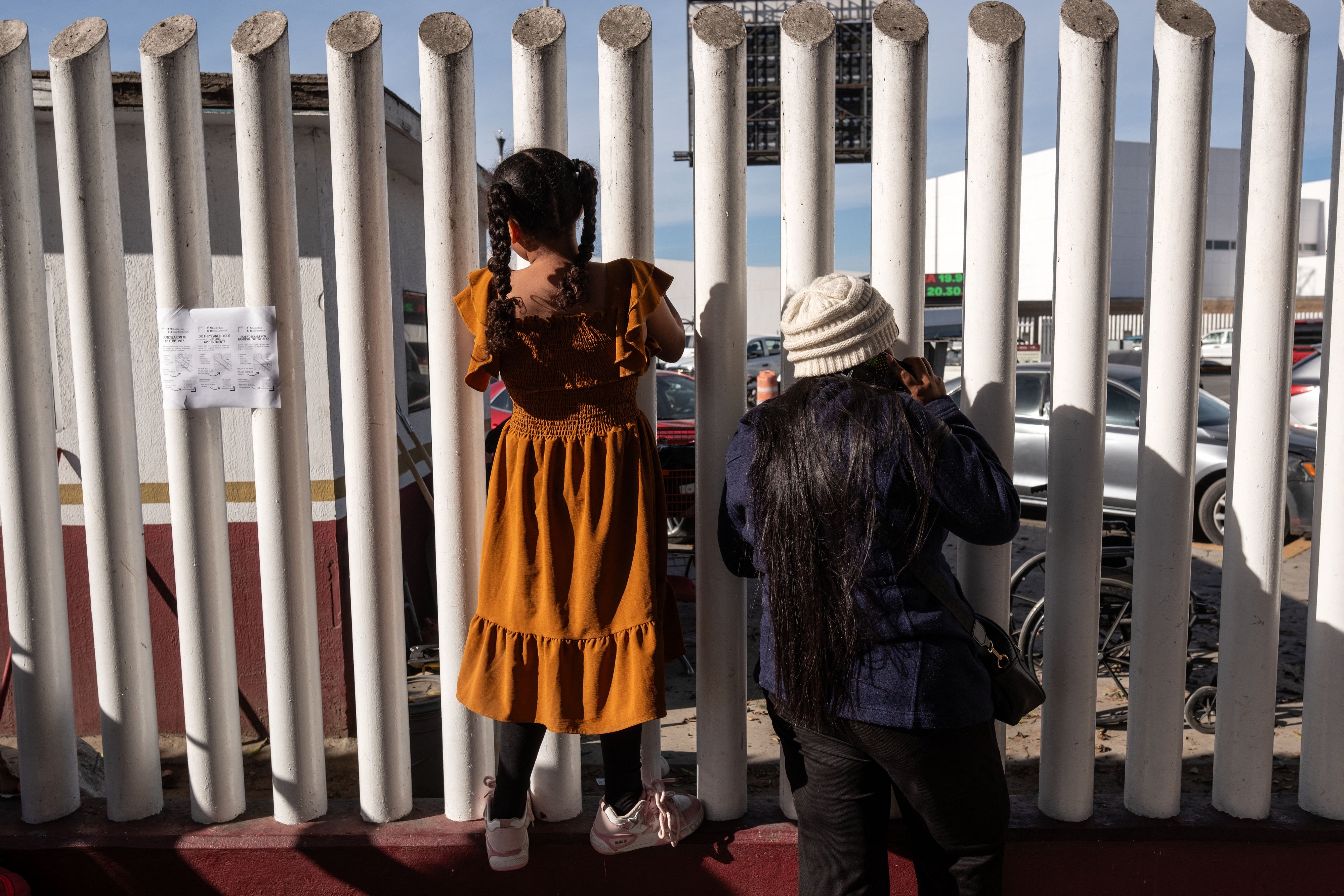 Asylum seekers wait for news on the CBP One appointments at El Chaparral crossing port in Tijuana, Baja California state, Mexico, on January 21, 2025. 