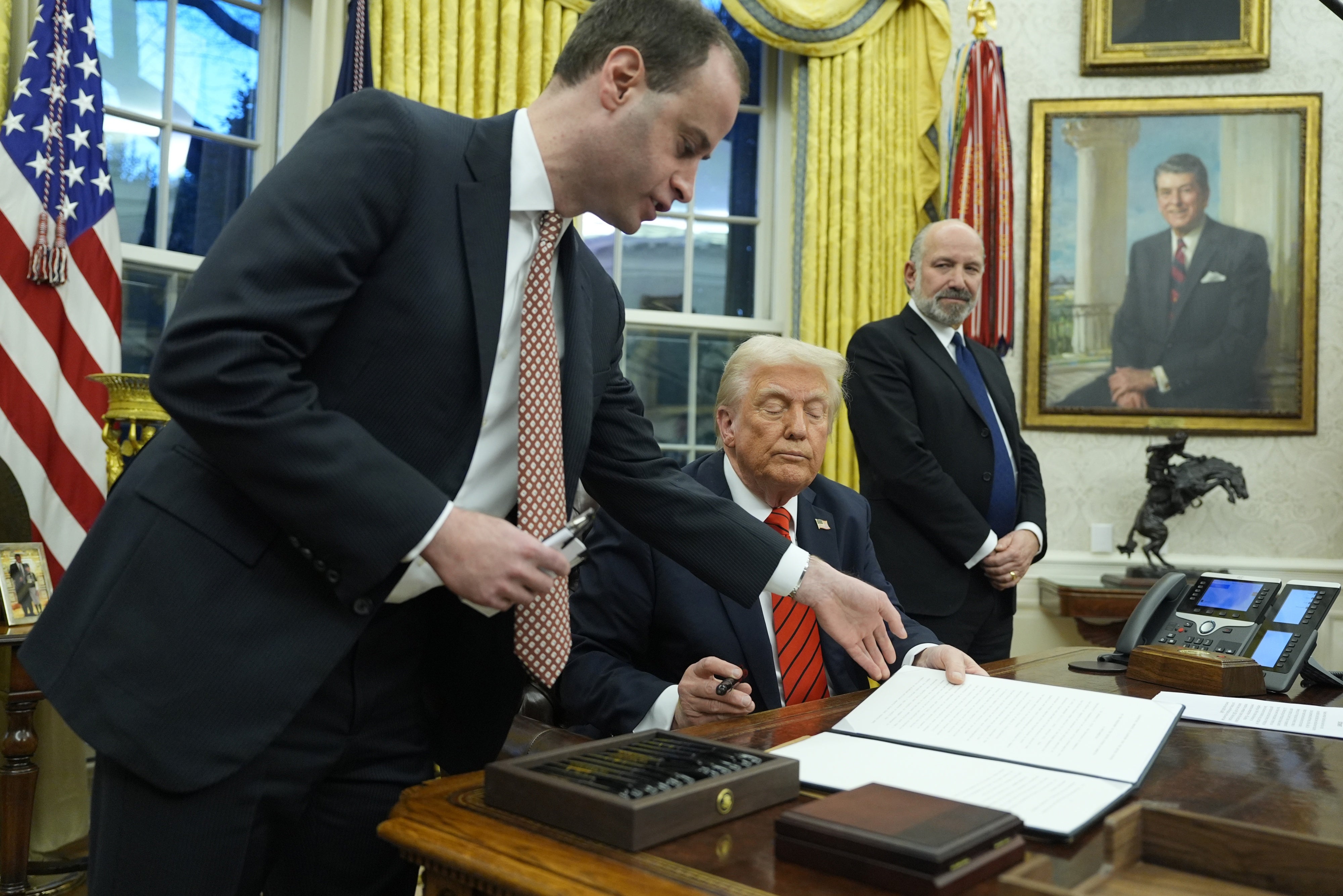 President Donald Trump signs an executive order in the Oval Office at the White House, Washington, DC, February 10, 2025.