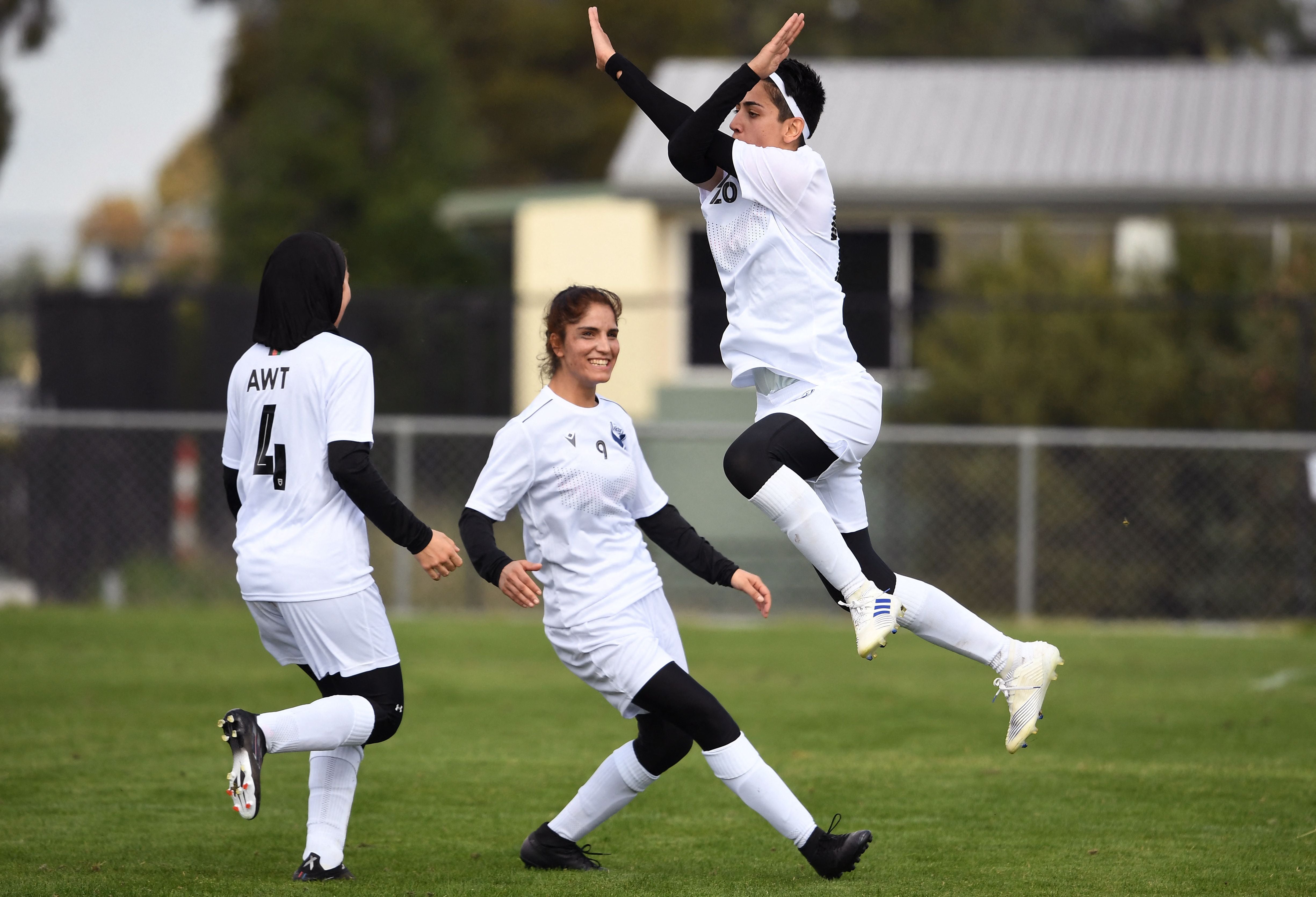 Afghan women's football team players celebrate a goal on April 24, 2022.