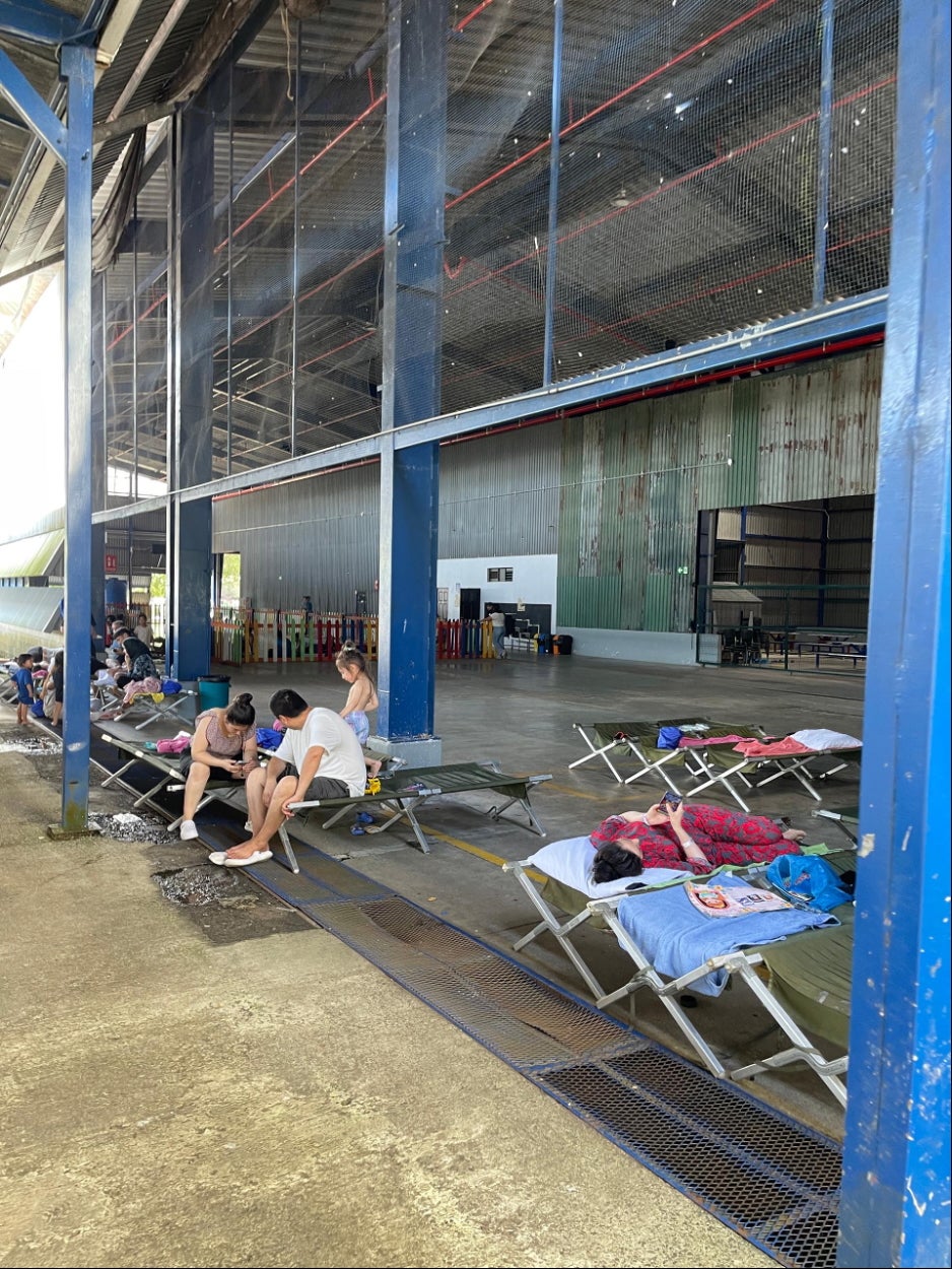 The interior of Costa Rica’s migration reception center in Puntarenas, showing the play area for children behind a row of cots.