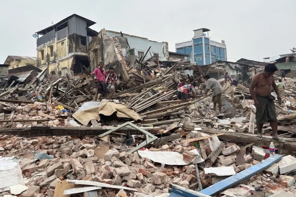 People clean debris from damaged buildings in the aftermath of an earthquake on March 28, in Naypydaw, Myanmar, April 7, 2025.