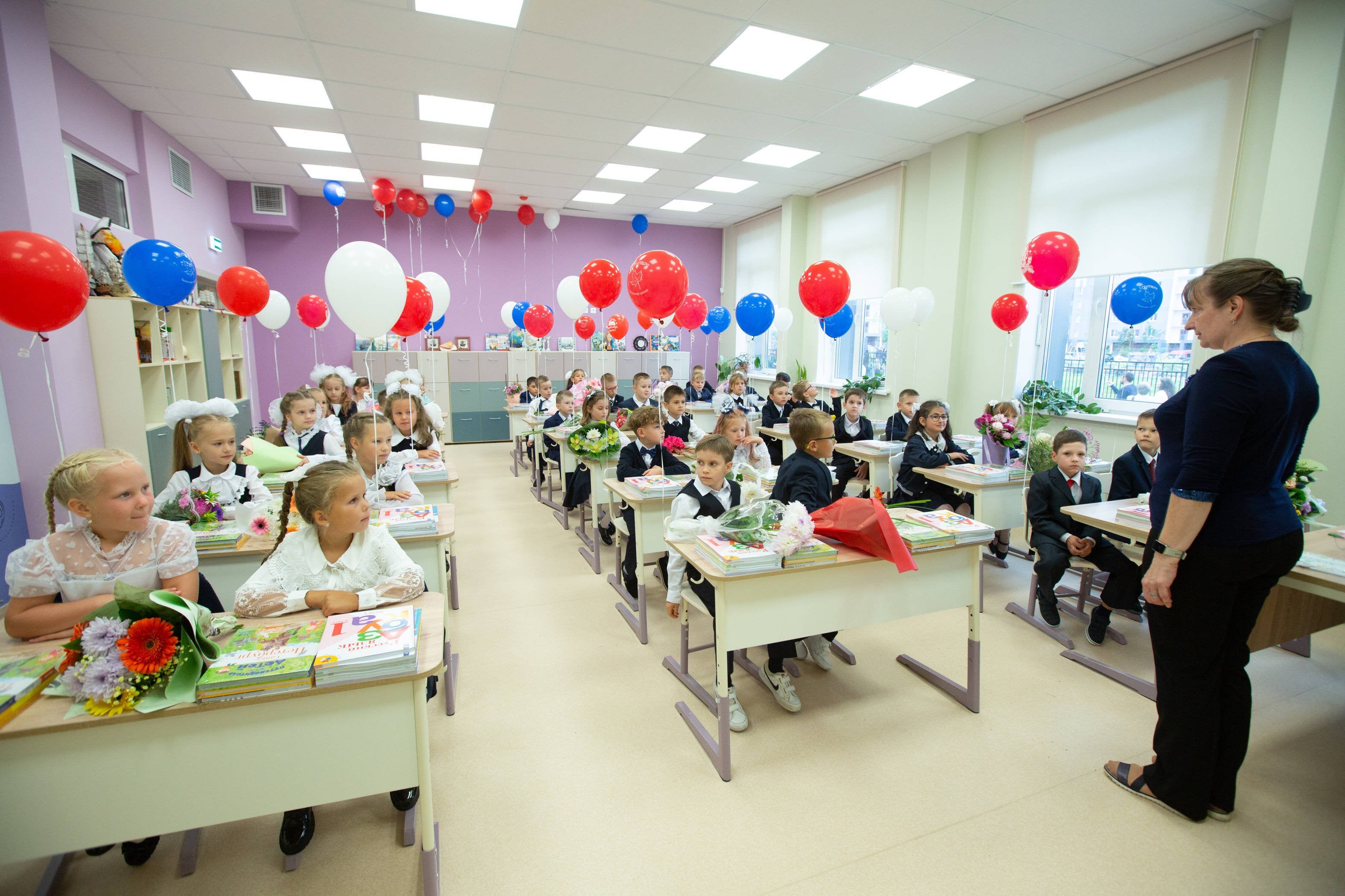 Children sit at desks in a classroom 