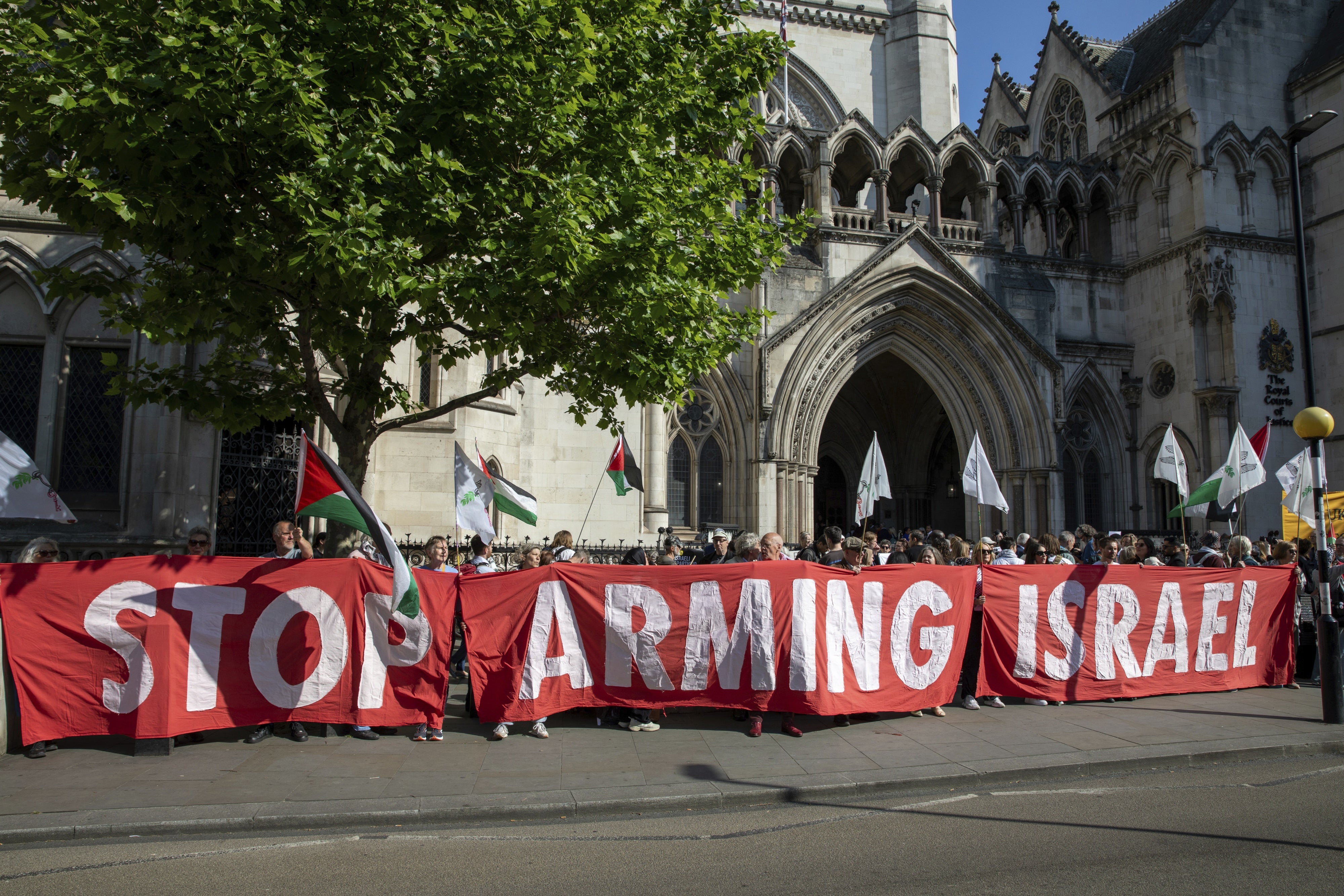 Activists hold a banner at a demonstration outside the Royal Courts of Justice in London, UK, May 13, 2025. 
