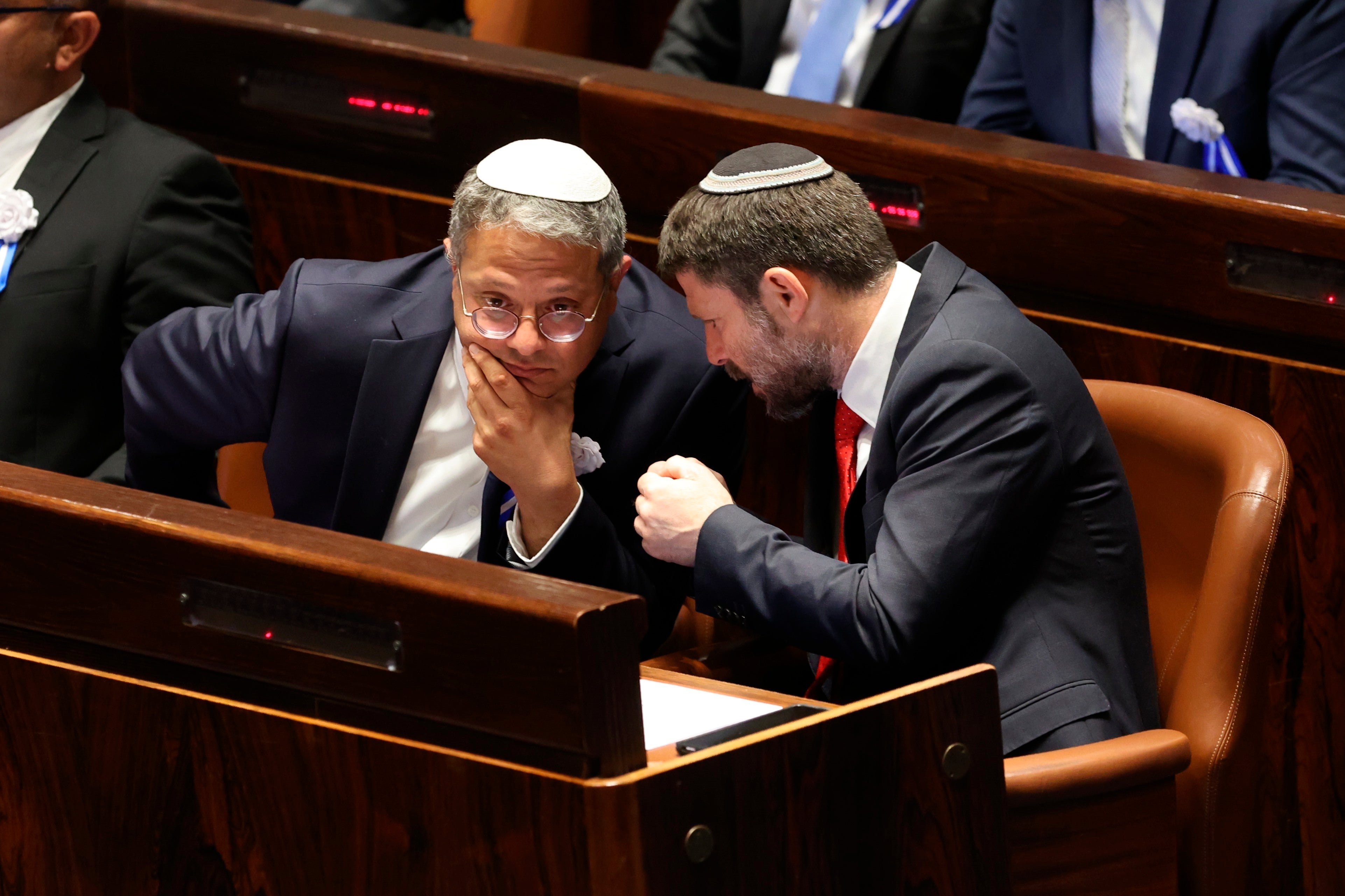 Former Israeli Knesset member and current National Security Minister Itamar Ben Gvir (R) and Minister of Finance Bezalel Smotrich speak in parliament, in Jerusalem, November 15, 2022.