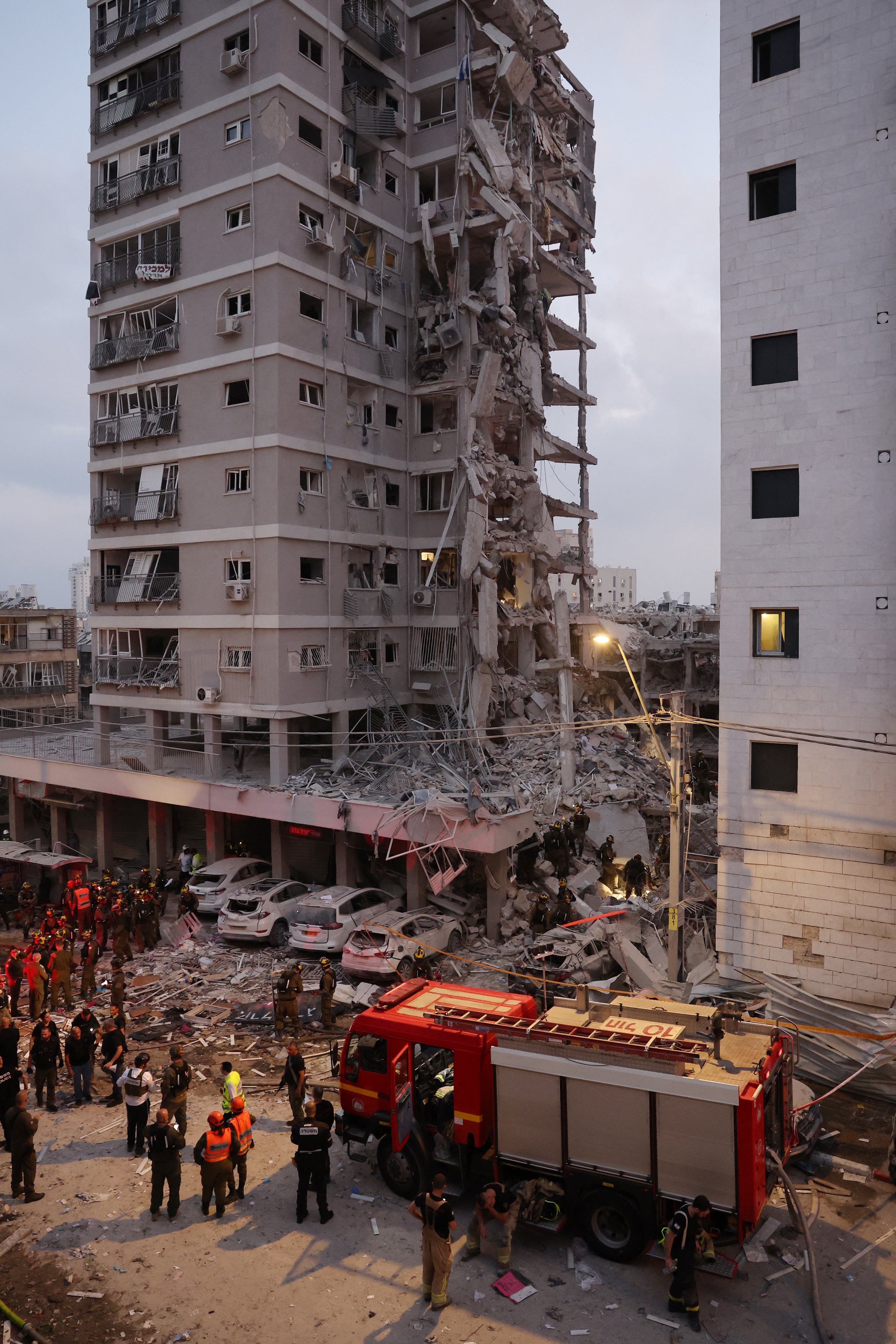 Responders amid rubble following a strike by an Iranian missile in the Israeli city of Bat Yam, south of Tel Aviv,  on June 15, 2025. The strike killed nine civilians, including three children.