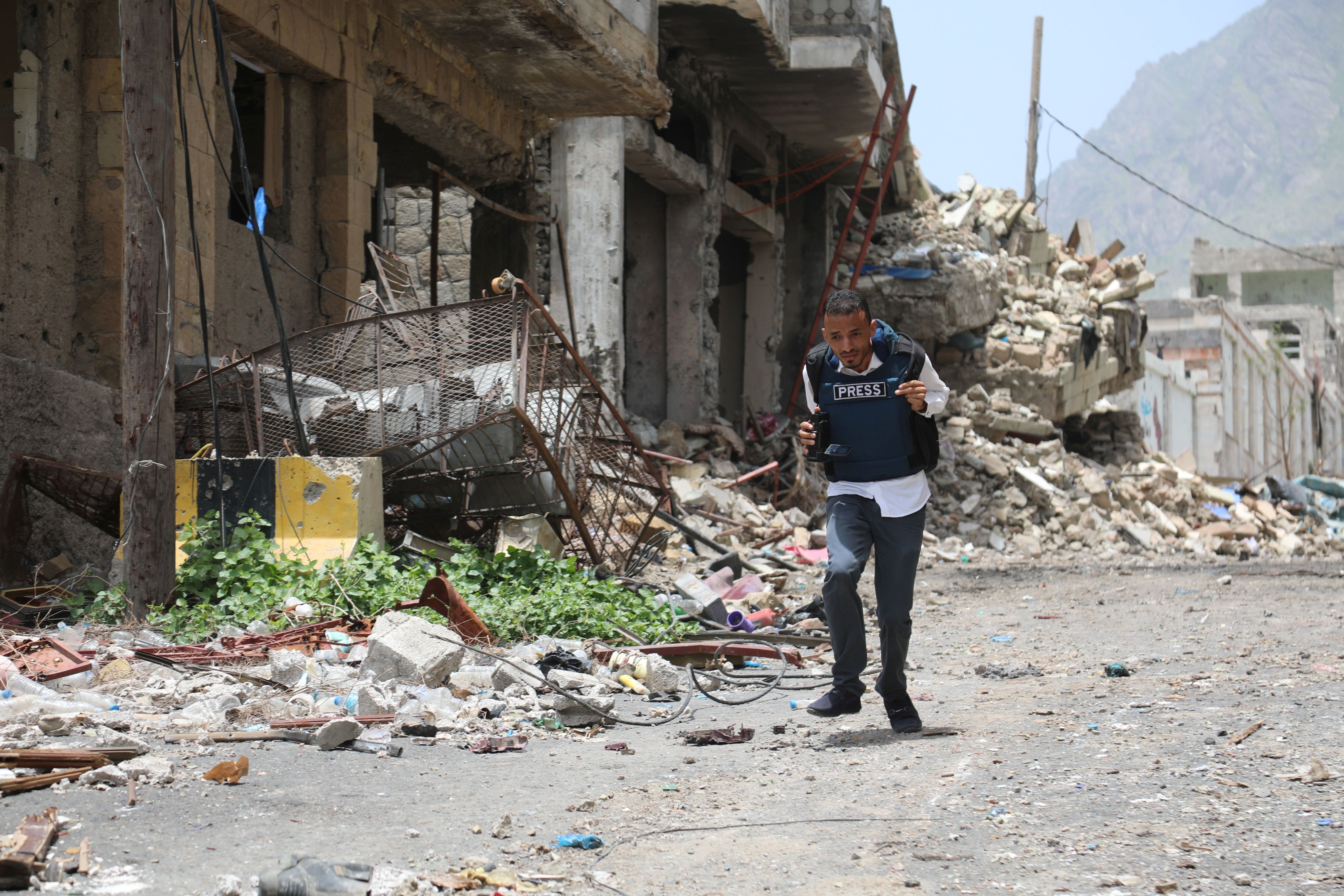A journalist running down a city street