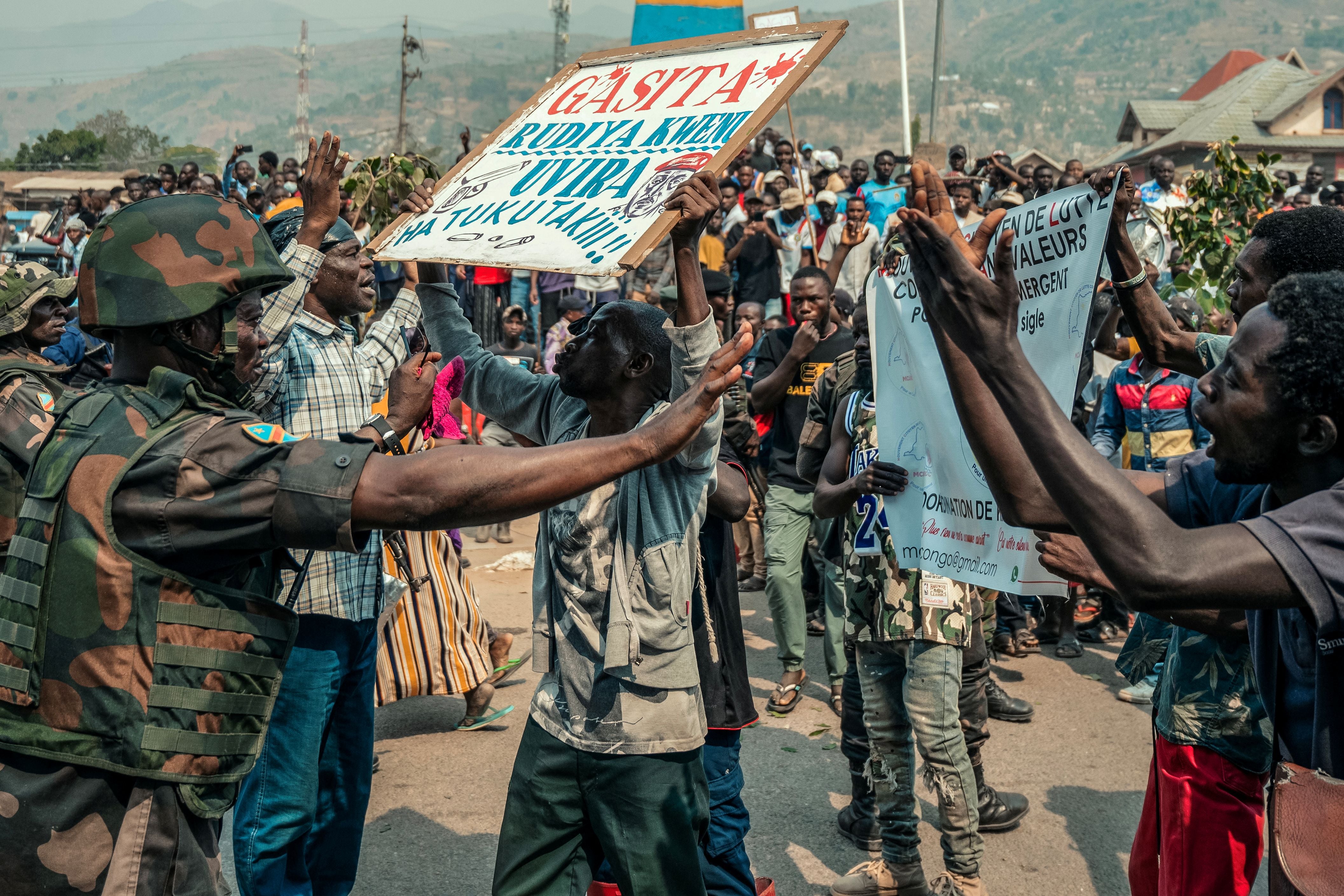 A protestor holds a placard in Uvira, DRC.
