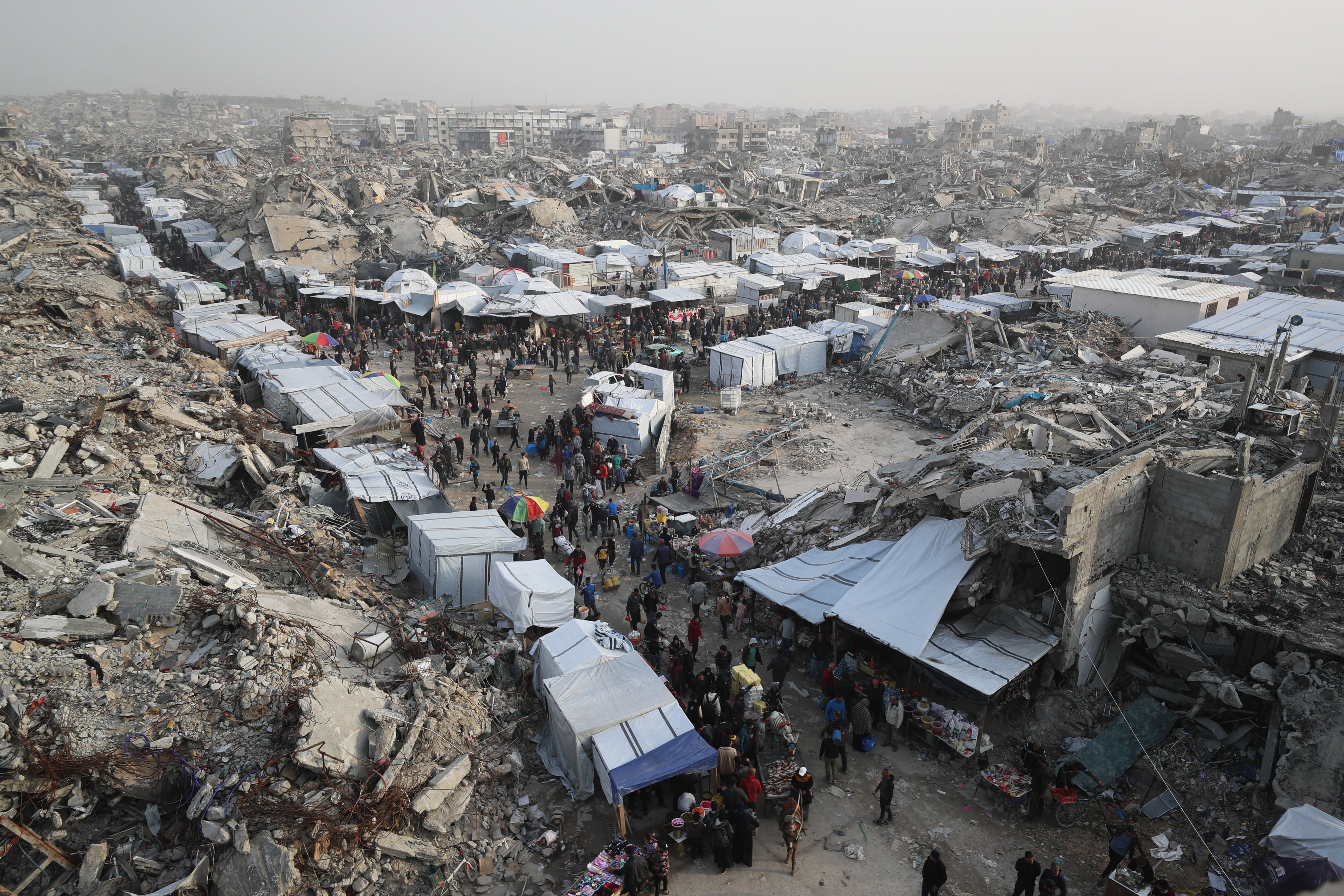 Palestinians shop at a market set up among rubble in the Jabalia Refugee Camp in northern Gaza during the temporary ceasefire between Israel and Hamas in early 2025, on March 5, 2025. 