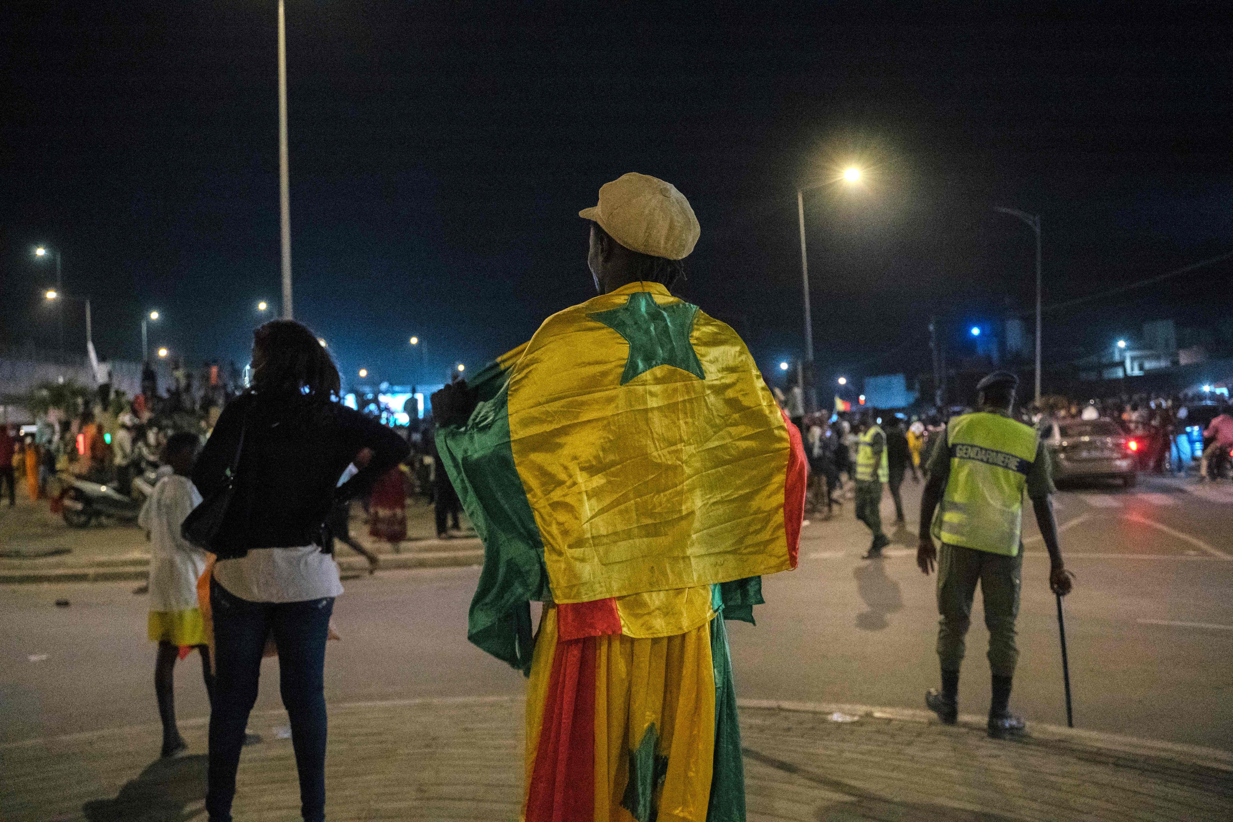 A supporter wears the Senegalese national flag in Dakar