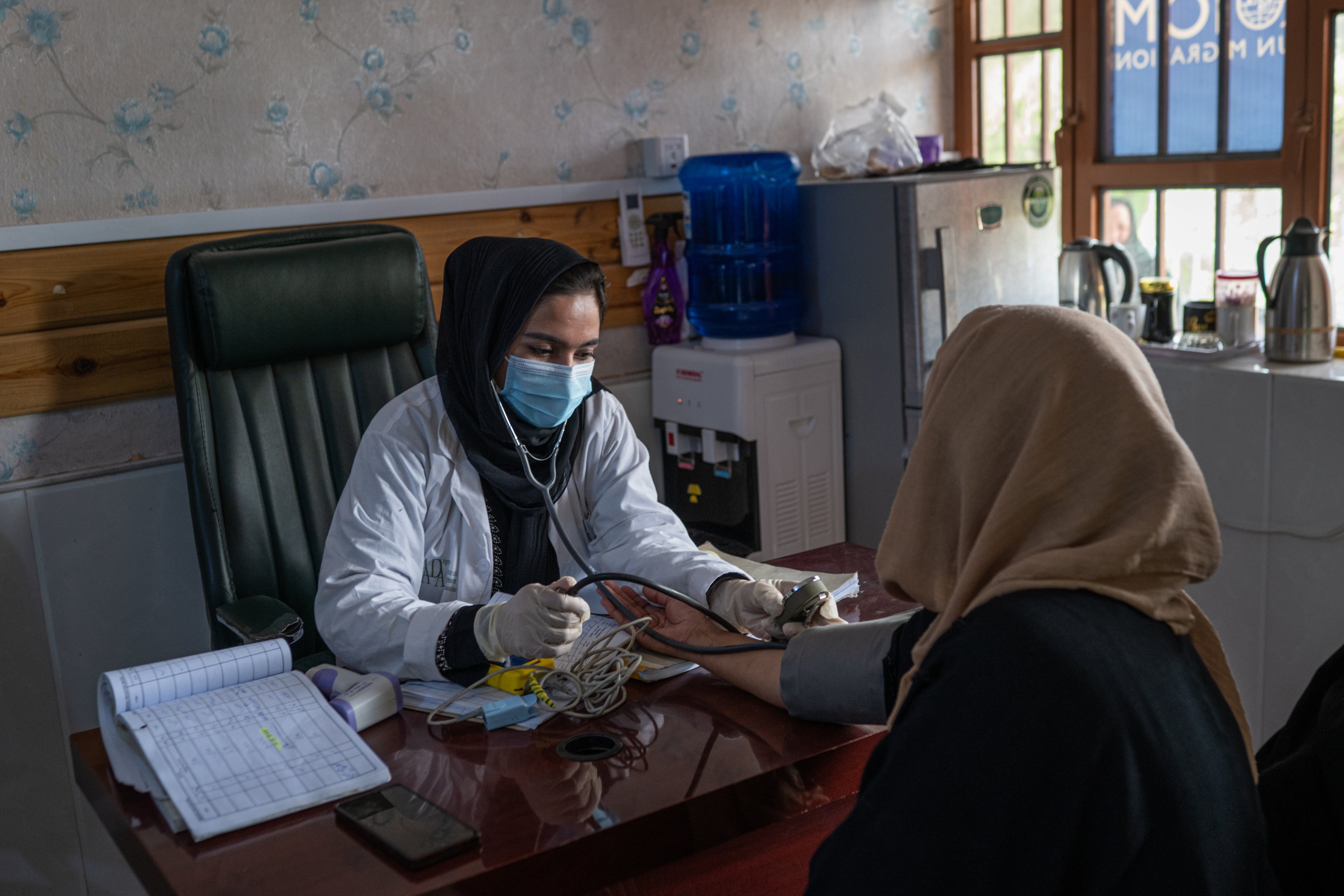 A doctor working with a UN agency examines a woman at a clinic in Herat, Afghanistan, July 5, 2025.