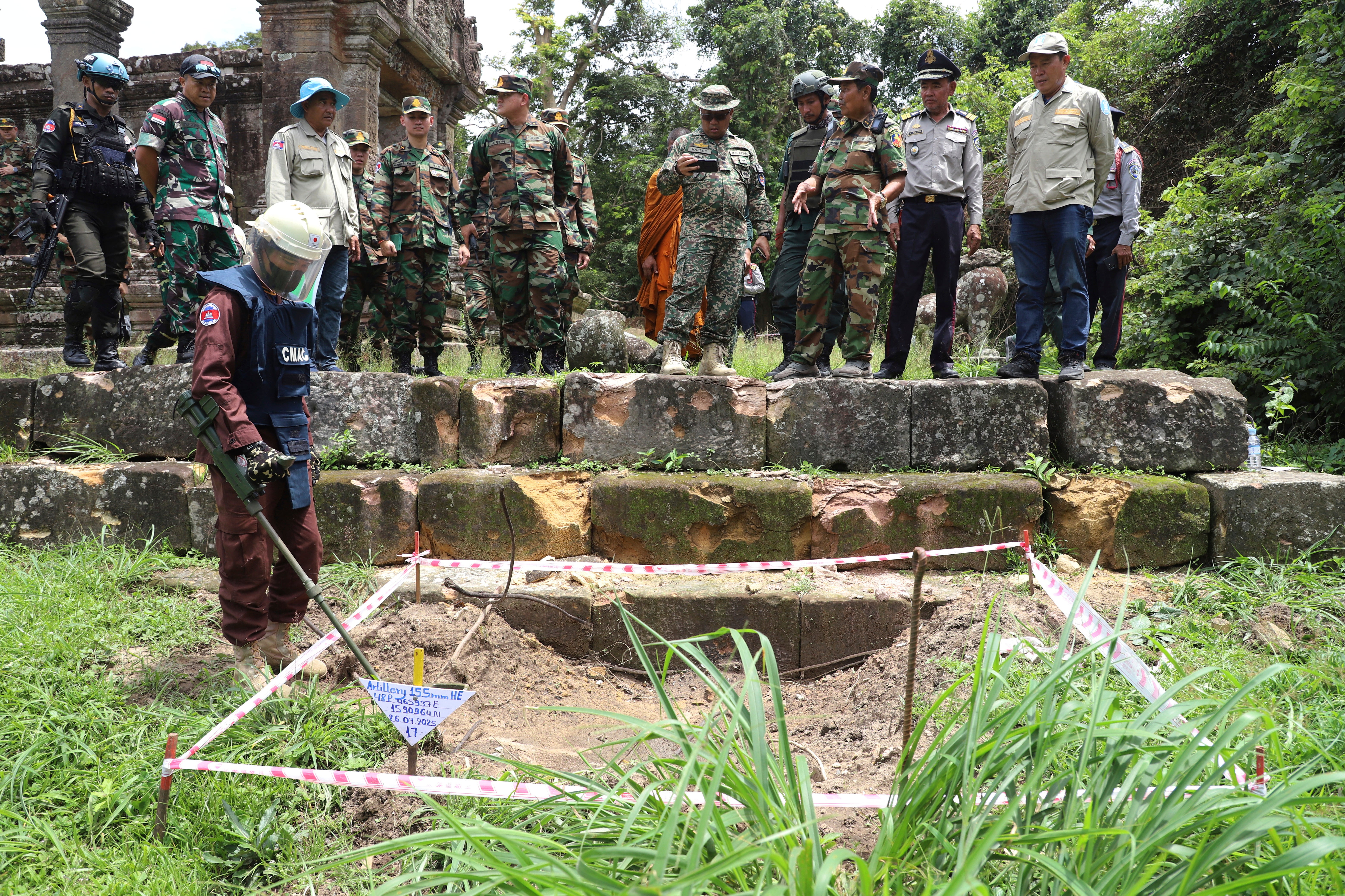Cambodian military personnel and international observers inspect damage from shelling at Preah Vihear Temple in Preah Vihear province, Cambodia, August 20, 2025.